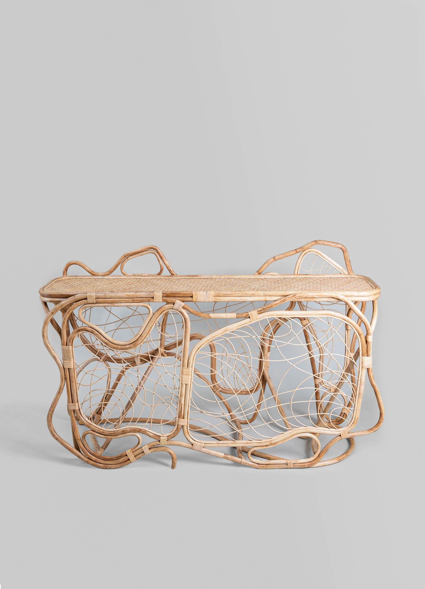 Chakra Console Table in Cane, Viya by Vikram Goyal

Perhaps nothing is more captivating than nature's enduring metamorphosis, persisting in graceful transformation even beyond the boundaries of life. In this enchanting ritual - one with an intimate