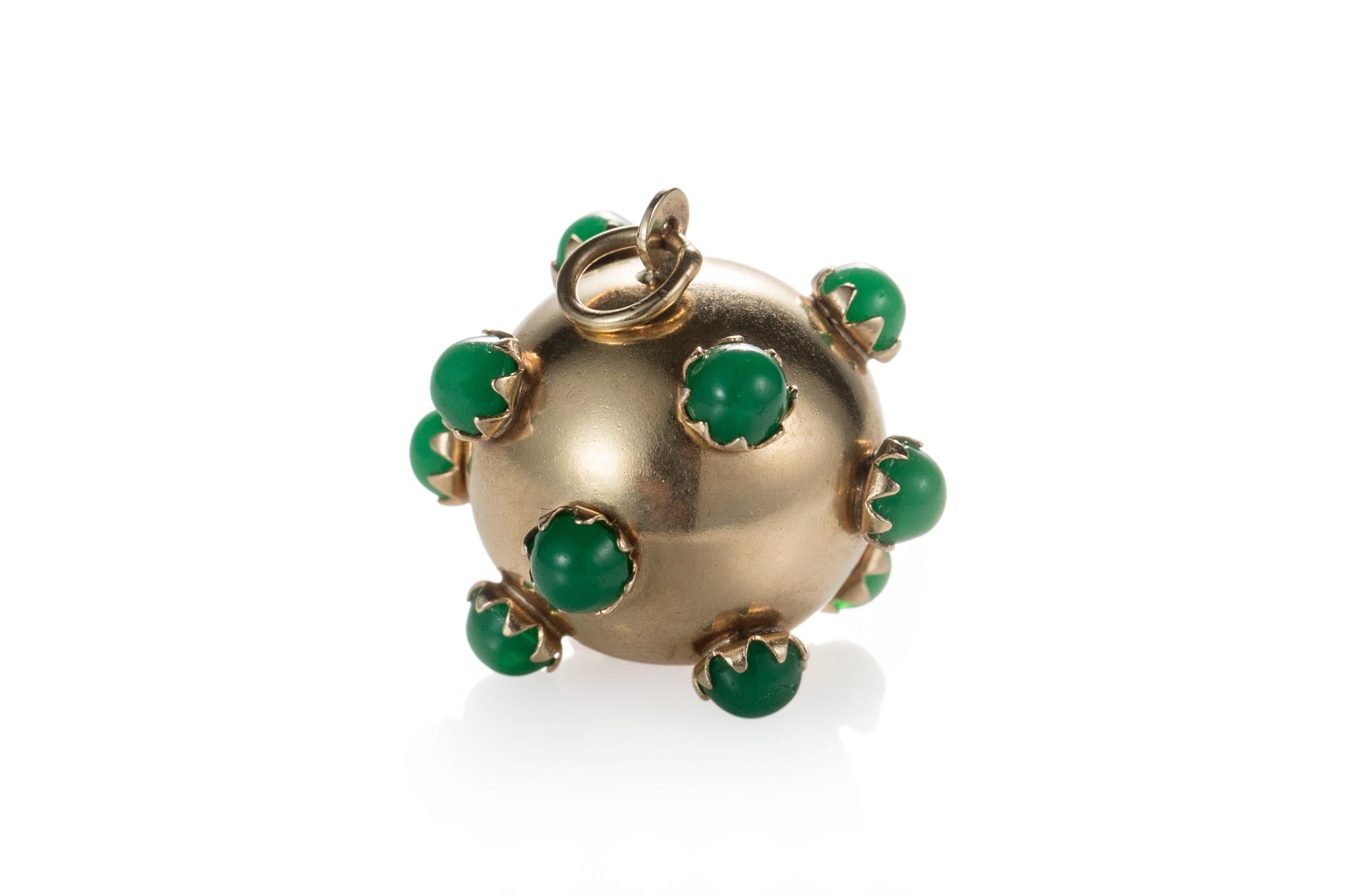 Metal Type: 18 Karat Yellow Gold
Weight: 5 grams
Size: 3/4 inch diameter 

Features several beautiful green Chalcedony cabochon gemstone. Each gemstone is prong-set with a sharp 'U' profile. 
This sputnik pendant is from 1945 and is absolutely