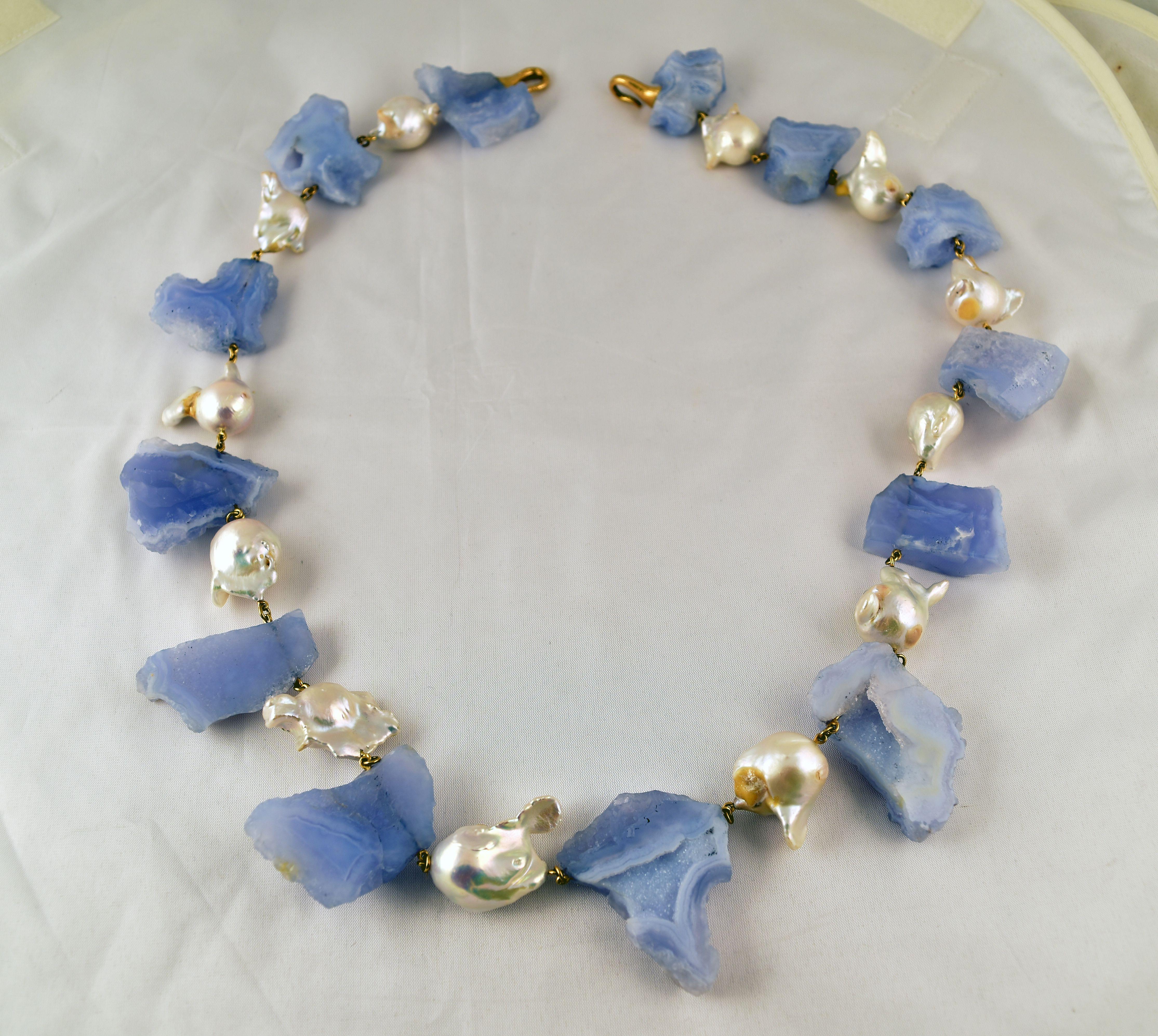 Beautiful Blue Chalcedony and Baroque Pearl Statement Necklace held by an 18K yellow Gold clasp, Chalcedony (app. 873 gram weight.); approx. 28 1/2” long x 5/8”-1 1/2” wide; by Tony Duquette, Designer Extraordinaire! A perfect complement to every
