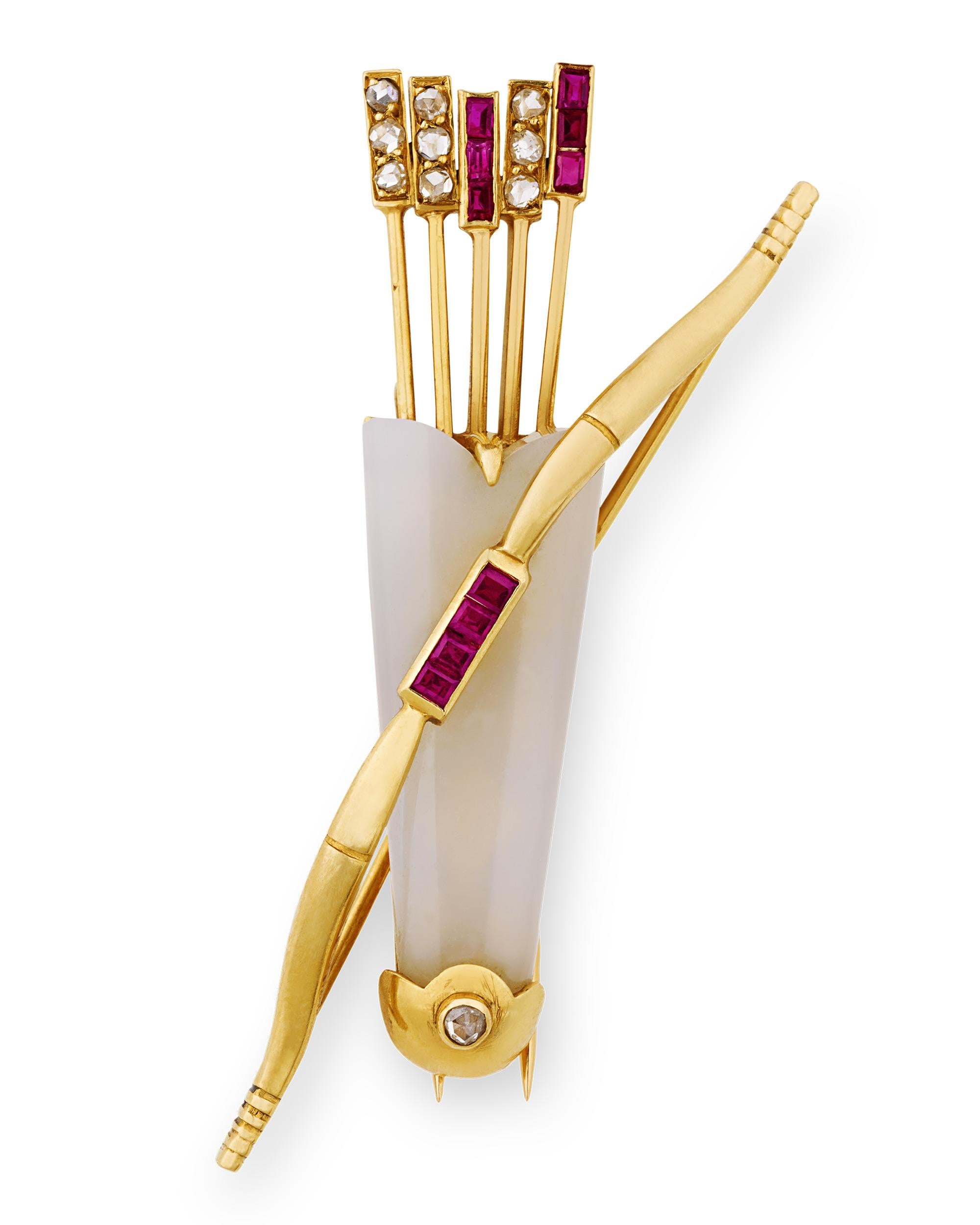Cartier created this rare and fabulous brooch depicting a sleek bow and quiver filled with arrows. The brooch is a study in elegance, wrought from chalcedony, rubies and rose-cut diamonds and onyx all set in 18K yellow gold. Cartier is one of the