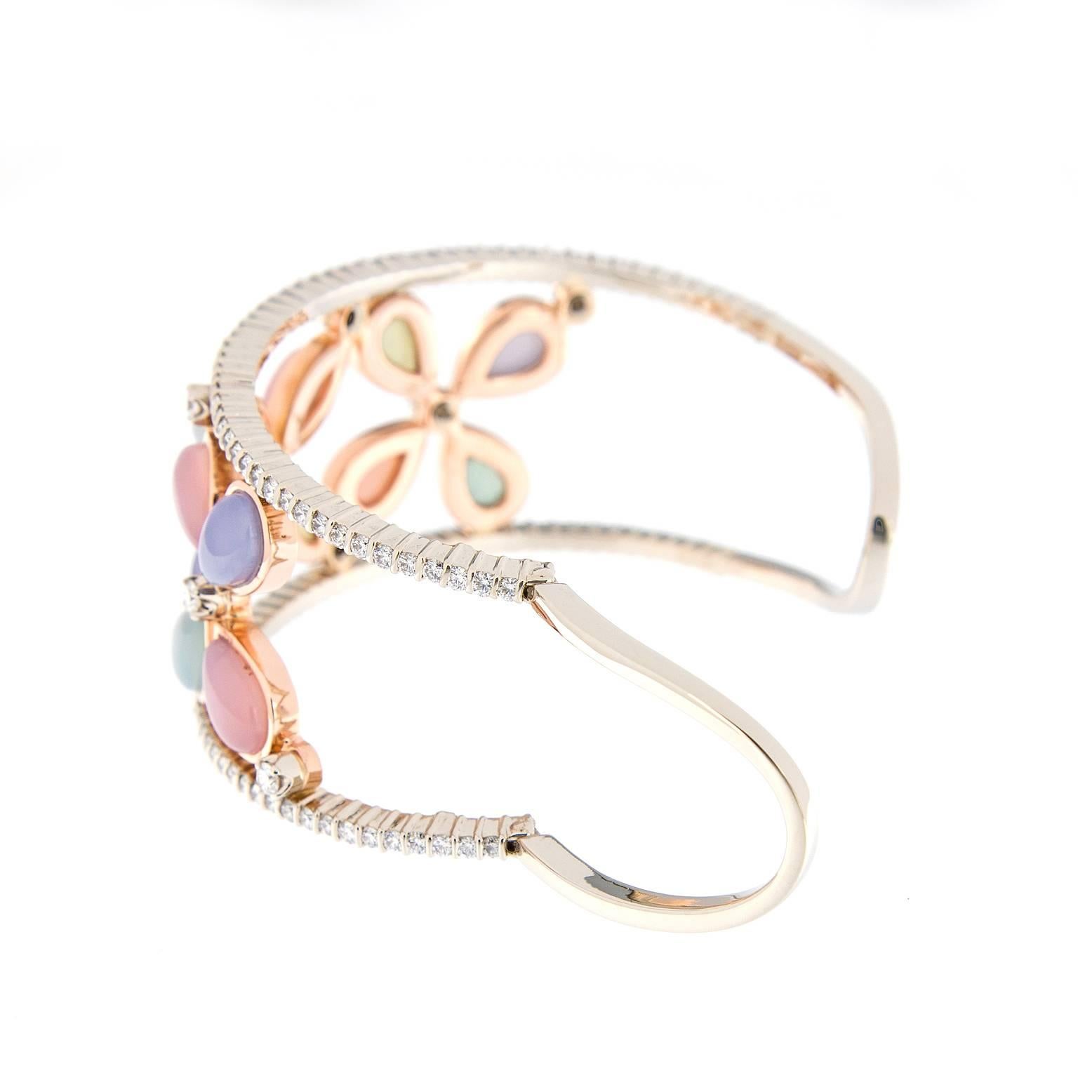 This 18k rose and white gold wide cuff bracelet features three open work floral designs with blue, pink and green chalcedony accented with over three carats of diamonds. Weighs 48.8 grams.
Handmade in New York

Diamond 3.30 cttw