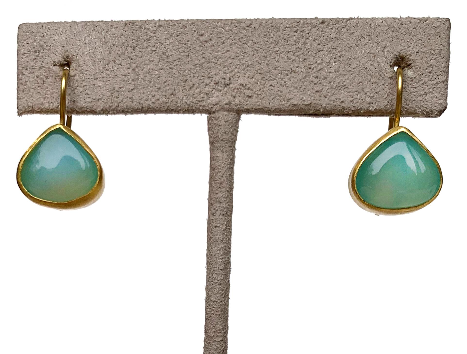 A gemstone that has been used since antiquity, this luminescent pair of chalcedony earrings is set in 22 karat gold with 20 karat gold earwire. Tear drop in shape with a cabachon finish. Entirely made by hand in New York City. 