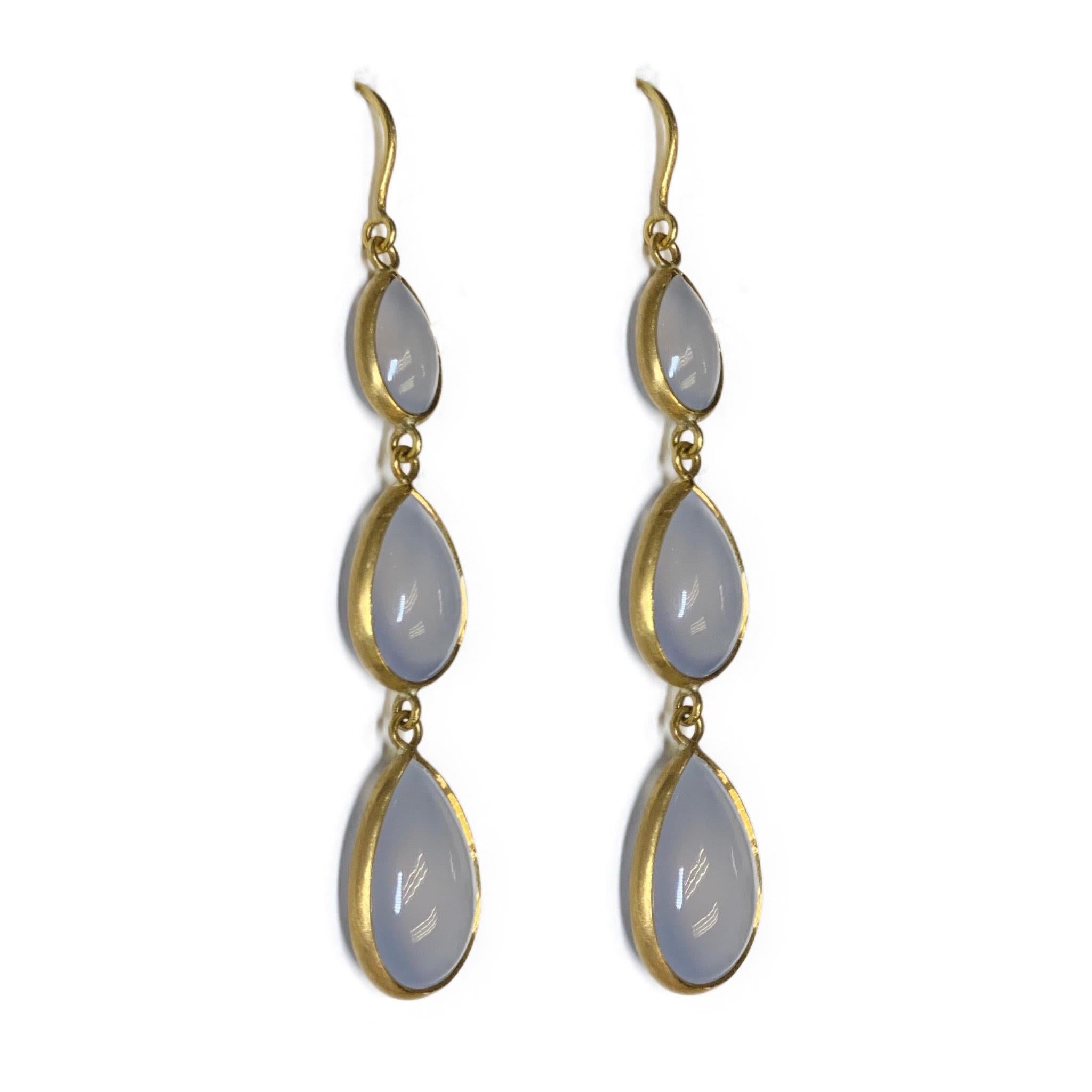 The custom-cut double sided Chalcedony drops are matched to perfection, and provide a sensuously soft silhouette when combined with the satin finished 22K gold. 
Chalcedony is a form of quartz. It is considered a powerful healing stone that can