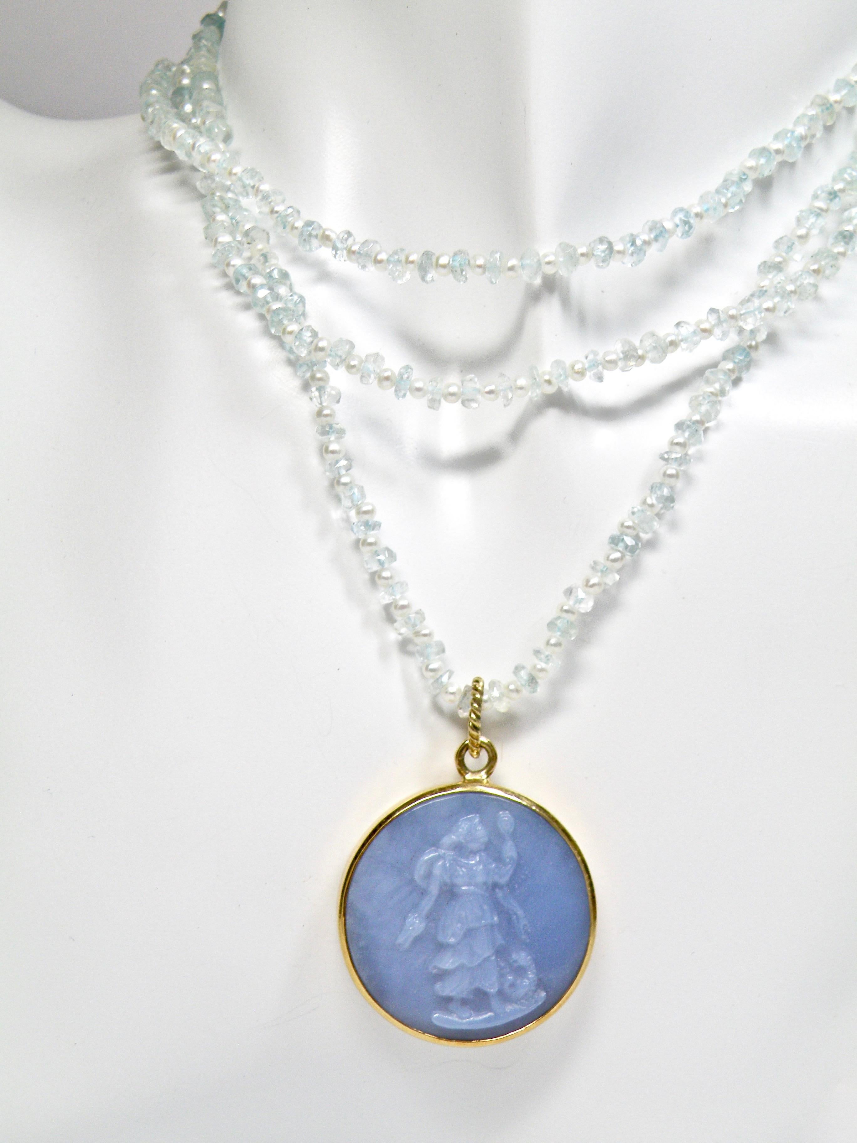 Hand carved chalcedony replica medal of the female figure of Prudence, who is historically associated with wisdom and virtue. Carved by Idar Oberstein, master carver. Set in 18karat gold frame with twist wire loop.
