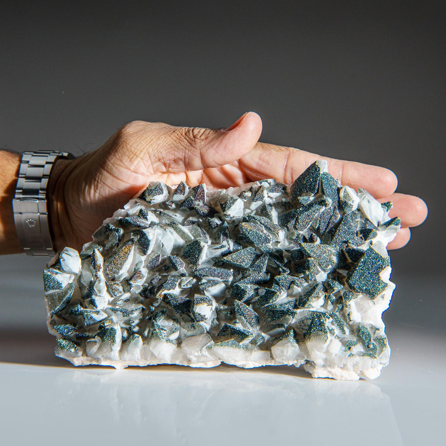 From Edong Mining District, Daye, Hubei, China

Cluster of sharp scalenohedral calcite crystals partially covered with lustrous iridescent metallic chalcopyrite crystals on the surfaces. Bright and lively color of blues ,greens and reds.


Weight: