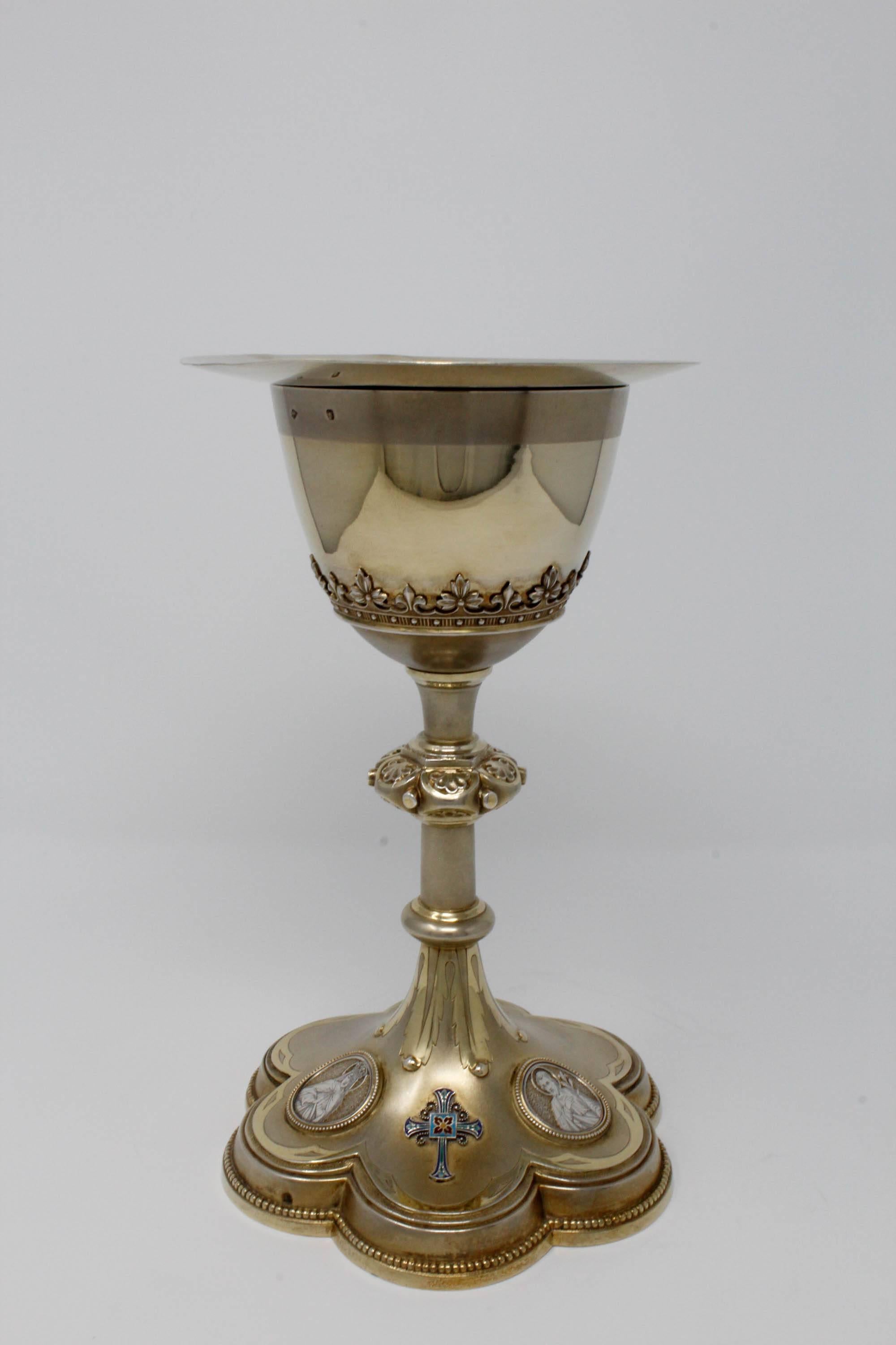 Chalice, Silver Gilt, D. Freres c.1880. The base is mounted with 3 engraved medallions & champleve enamel cross.

Material: Silver Gilt
Maker: D. Freces
Year: c.1880
Dimensions: 9