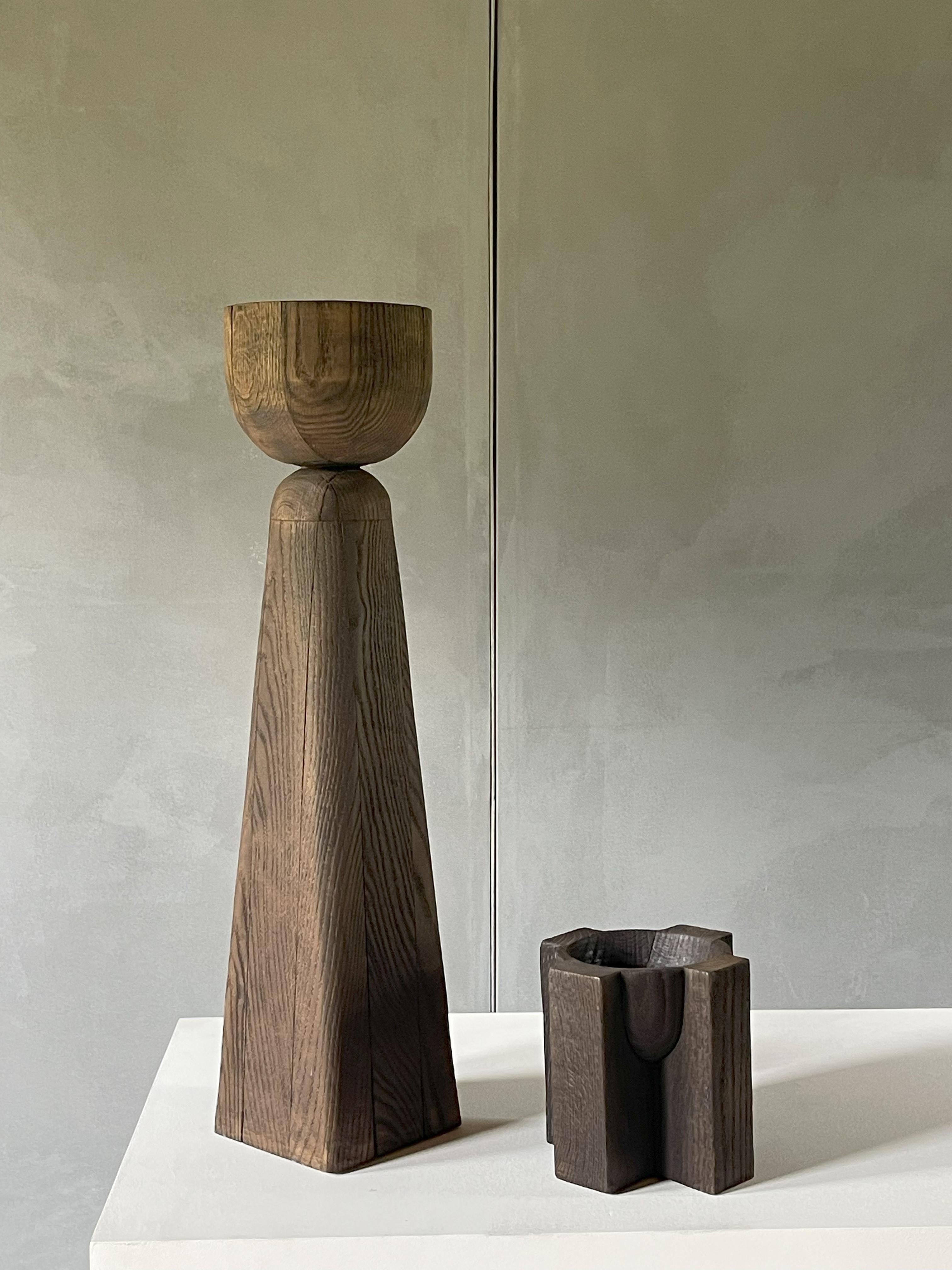 Chalice Vase / Arno Declercq
2017 / Burnt Iroko Wood
20 x 20 x h80 cm

prototype (unique piece)

Totem, stele, vase, tidy, candleholder… Chalice is all this at the same time. A rarity and a curiosity, mysterious and almost shadowy, as imposing in