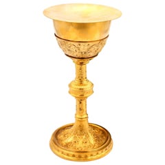 Chalice with gilded silver paten with reliefs, friezes and circular base
