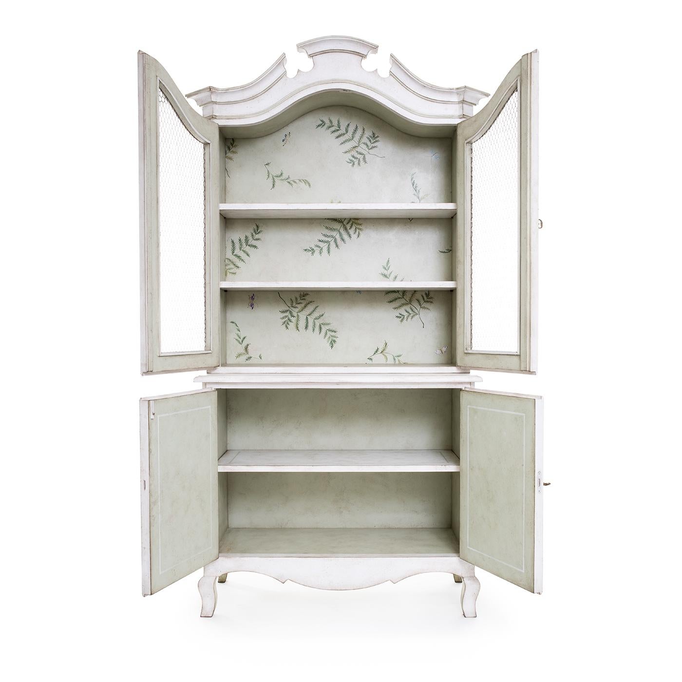 Presenting the Padua Hutch, a delightful addition to your living space. This lovely hutch, hand-painted in a captivating chalky white, instantly brightens your living areas. Its see-through design, crafted with intricate chicken wire and adorned