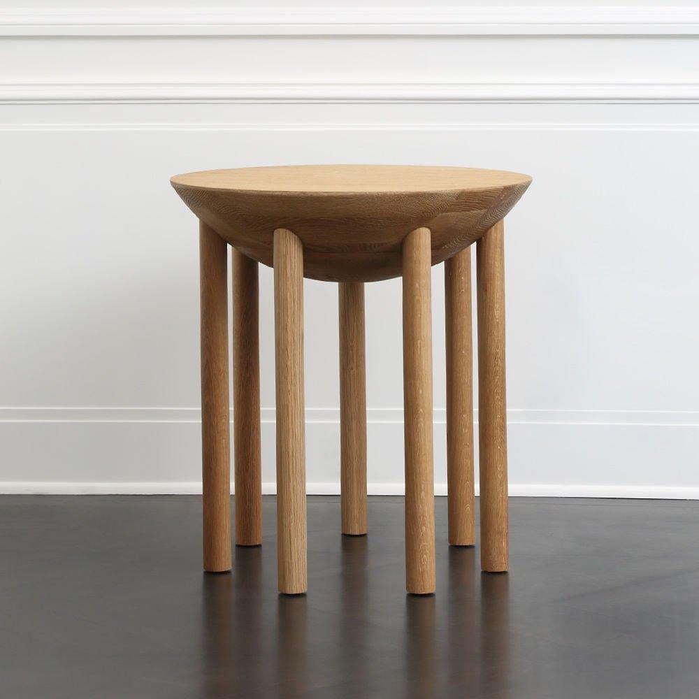 With its solid oak construction, deep rounded belly and array of slender legs the Chalon side table has a modern and architectural silhouette. The wire brushed finish, however, which accentuates the natural grain of the wood, gives the piece a