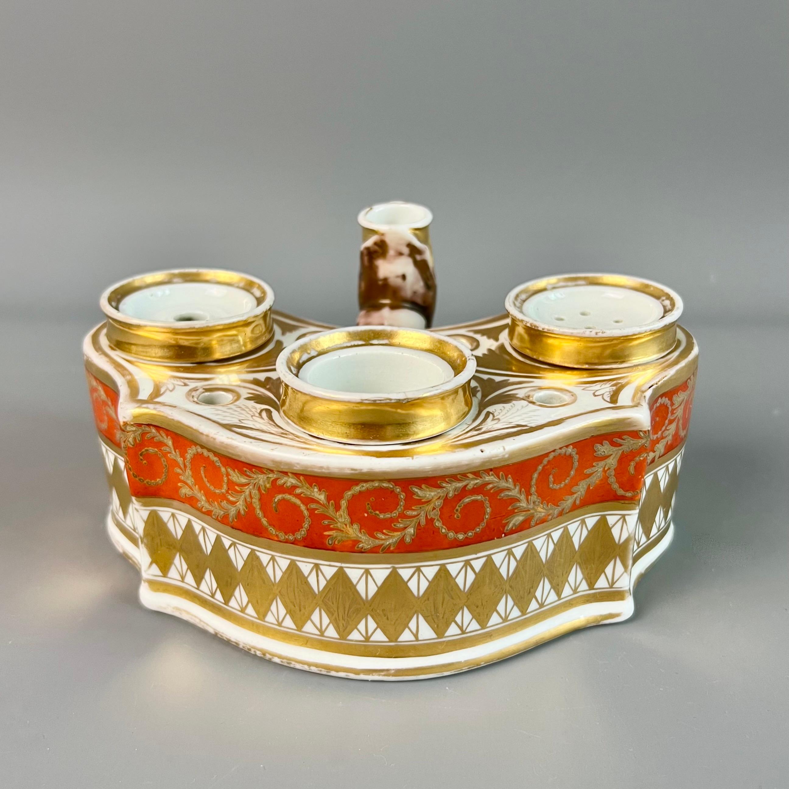 This is a splendid three-well ink stand or writing desk set made by Chamberlains Worcester in about 1810. The ink stand contains a stand with a pen holder or candle holder in the shape of a serpent's mouth, and three removable wells; one for ink,