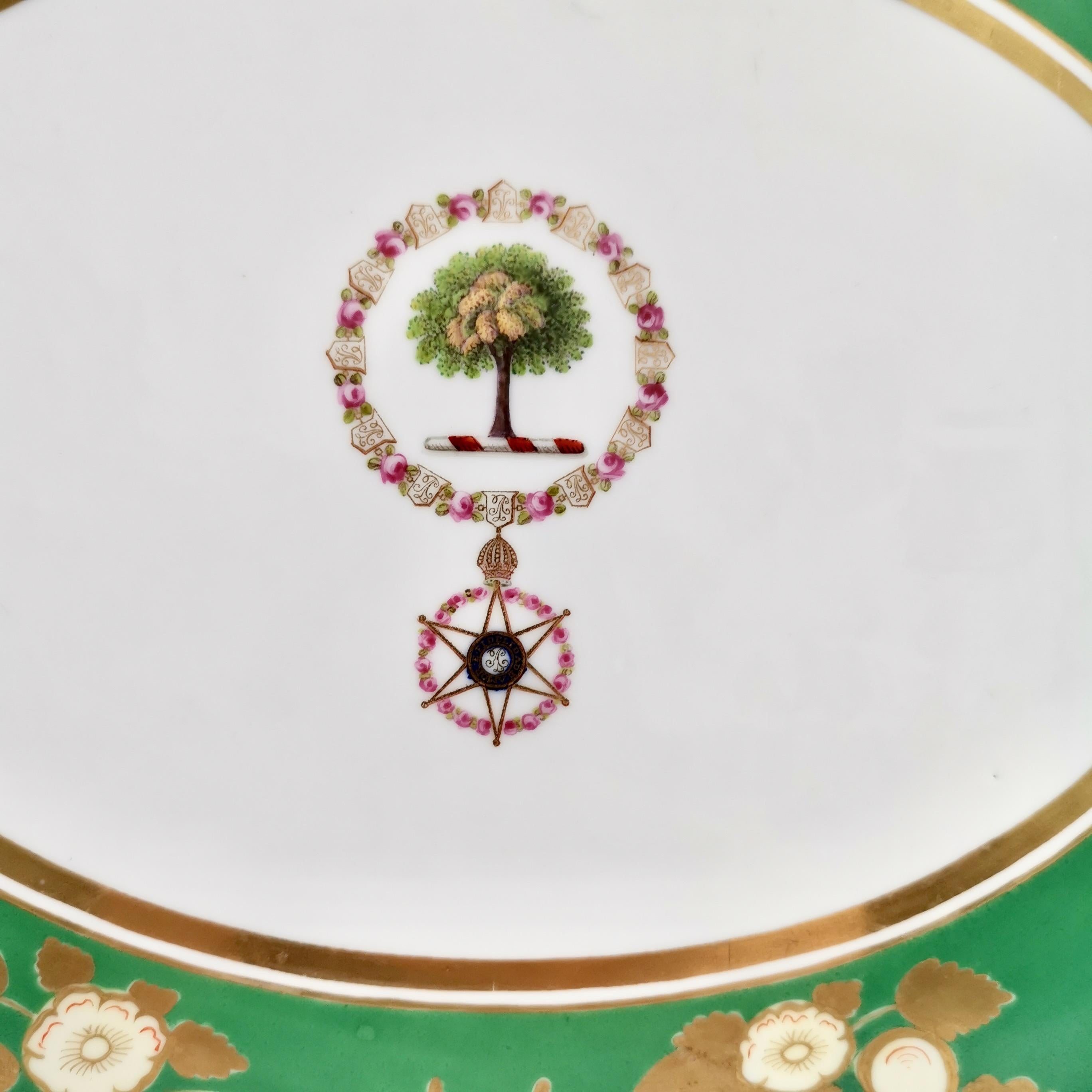 This is a historically important meat platter made by Chamberlain's Worcester between 1829 and 1837. It has an emerald green ground with floral reserves and the Collar and Medallion of the Brazilian Imperial Order of the Rose with the motto 