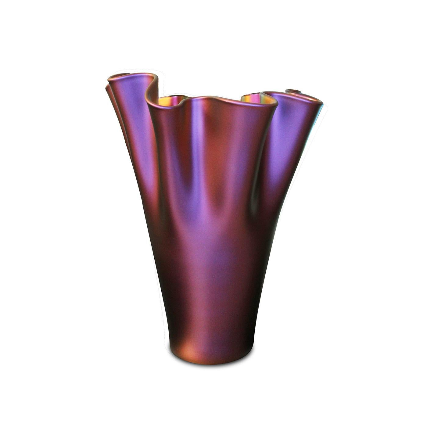 The Chameleon Wrap Vase offers a stunning decorative element for any home. Its draped glass form is accentuated by a lustrous, iridescent finish that transforms in color depending on the viewing angle. This captivating piece is designed to draw the