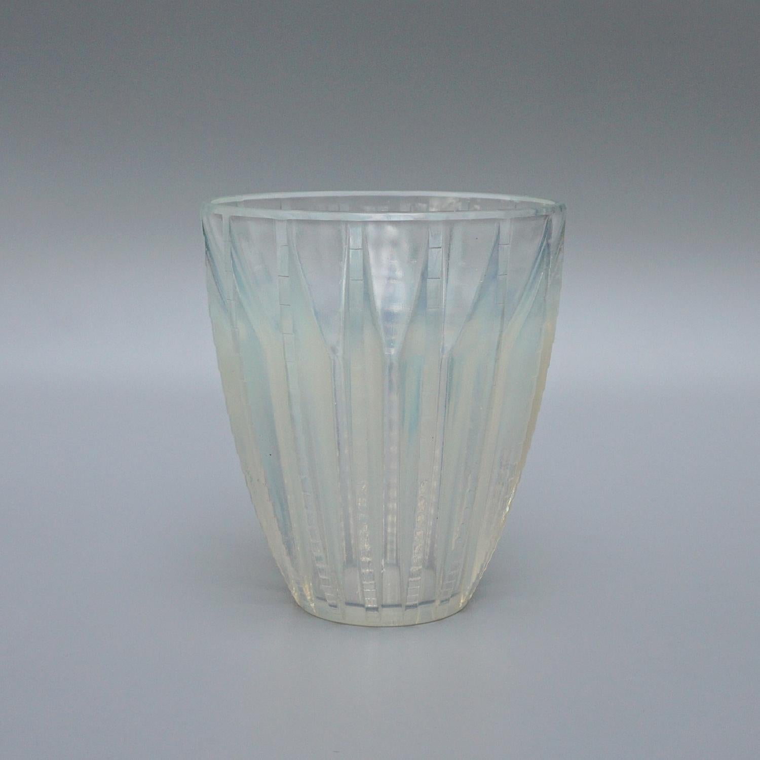 Hamonix, an Art Deco frosted and opalescent glass vase by René Lalique. Relief decorated with stylised pattern. Stencil etched R Lalique France to underside.

Literature: Marcilhac, R Lalique Catalogue Raisonné de L’Œuvre de Verre p.458, Model