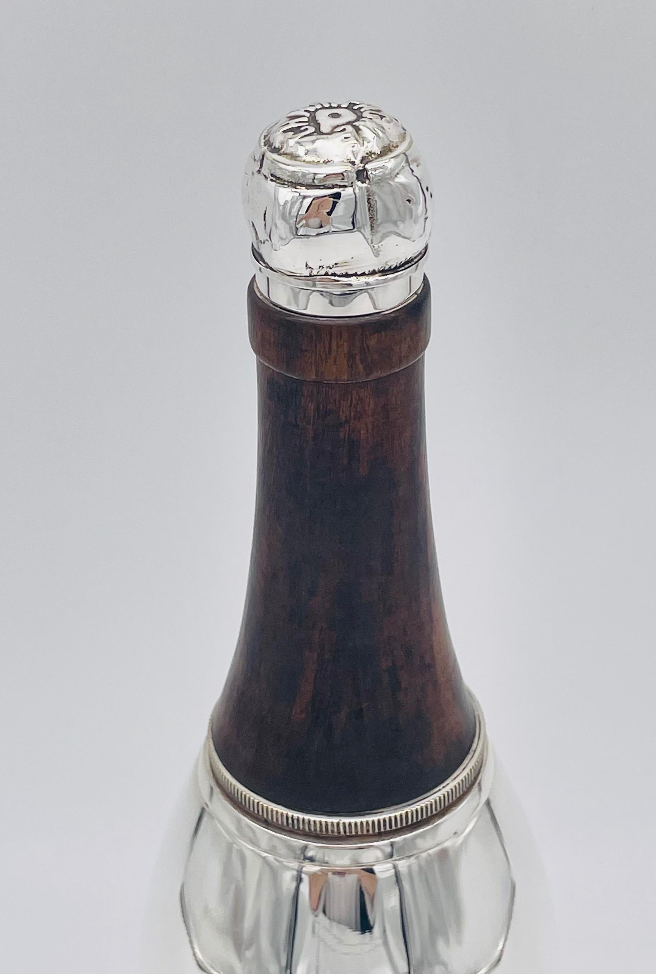 An English novelty cocktail shaker in the form of a champagne bottle.
There were several different novelty cocktail shakers made in the 1930s and 40s, and their popularity and rarity have meant that many are now being reproduced. This one is an