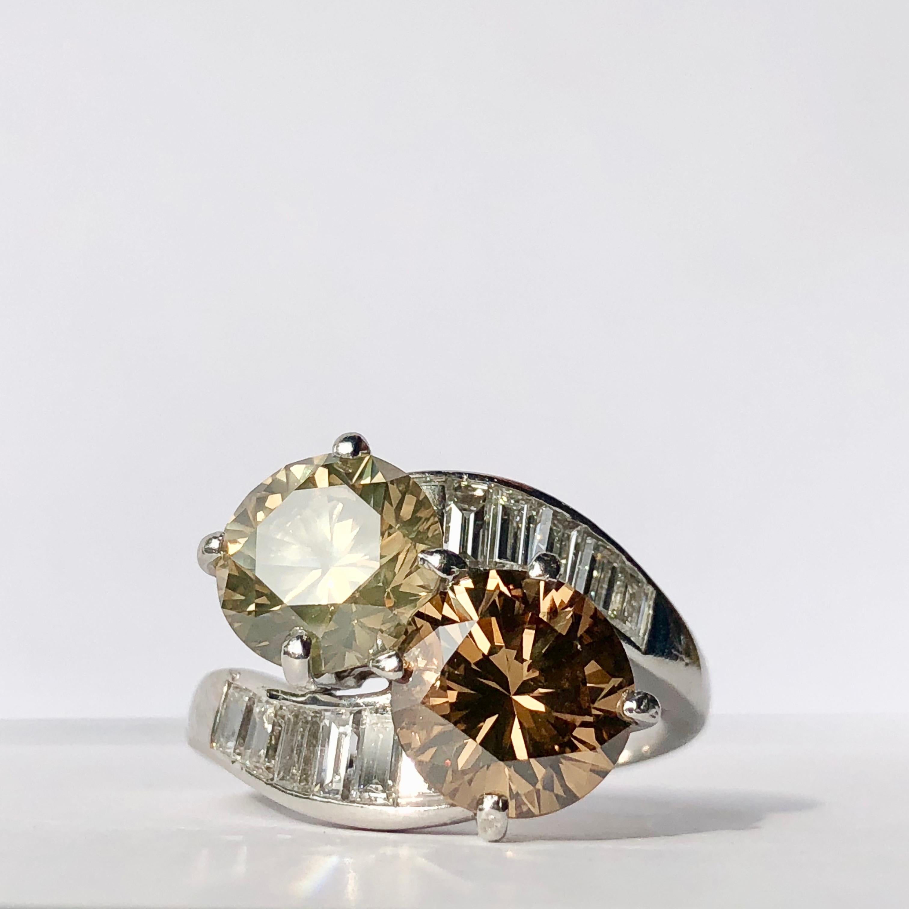 A Platinum, Champagne Colored Diamond and Chocolate/Cognac Diamond Toi et Moi Ring With White Diamond Baguette Shoulders 

An Incredible 5.40 ct Total Weight 

This really is a thing of beauty 

The warm, radiant glow of a cognac diamond makes for