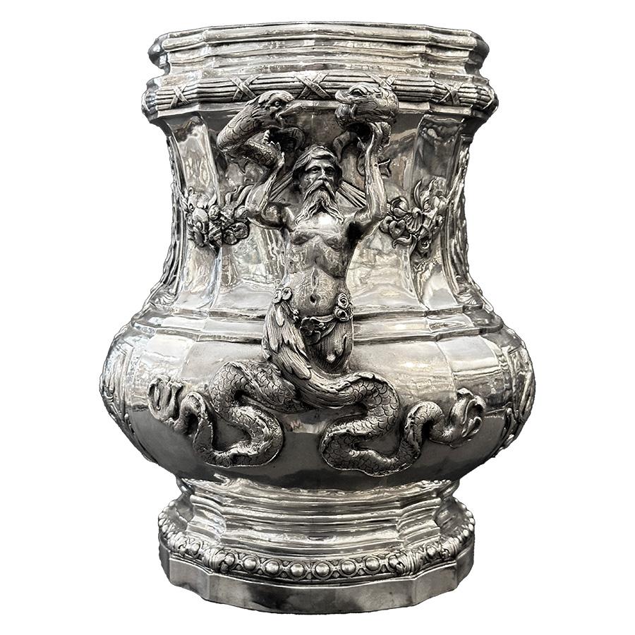 Indulge in the splendor of this magnificent solid silver champagne bucket, crafted with exquisite silversmithing skill. Reflecting the style of Meissonnier, this masterpiece hails from Germany, likely Hanau, around 1900. Resting gracefully on a