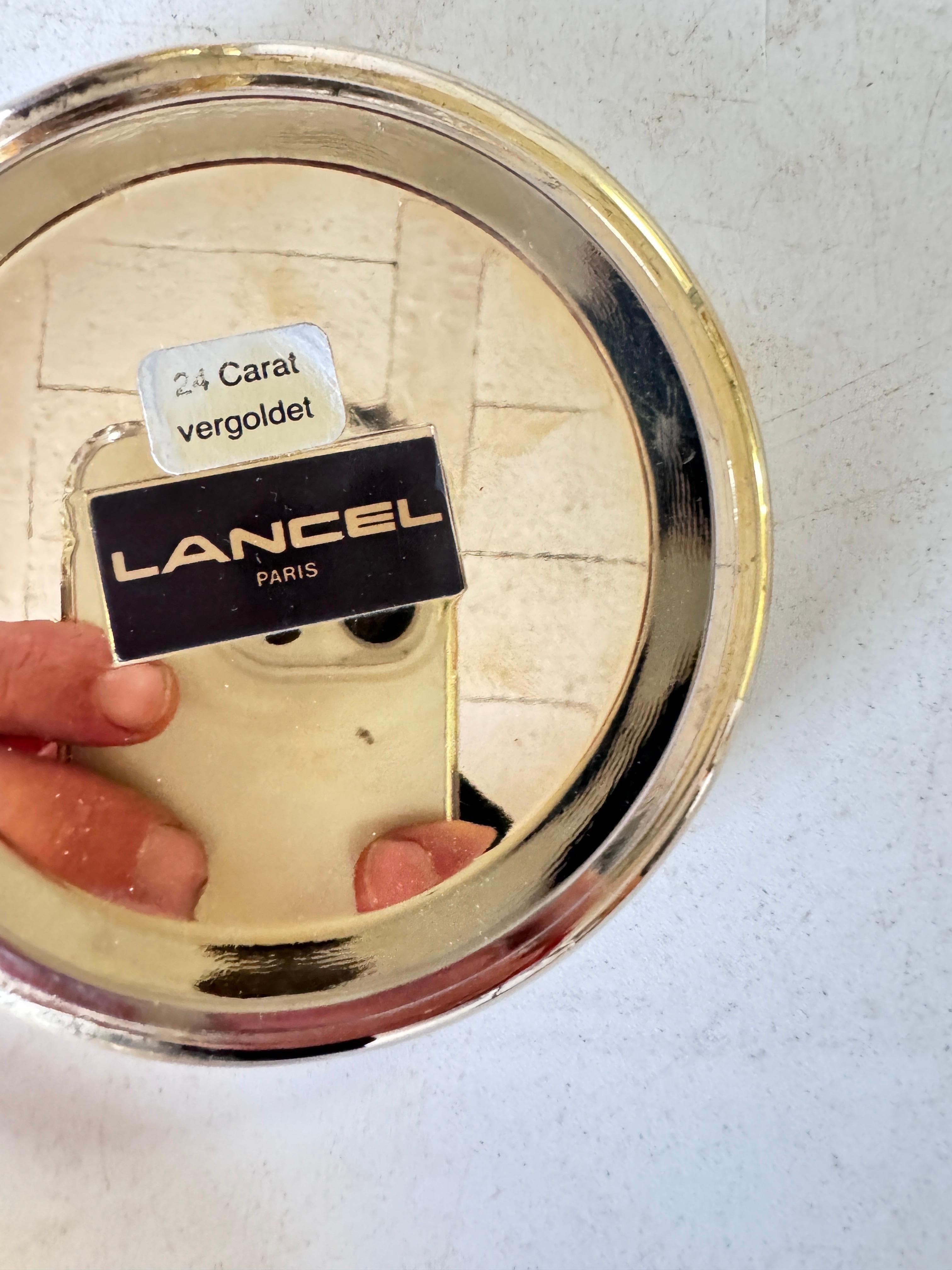 Champagne bucket in Chrome  and Gilt Metal
Ice bucket. By lancel Paris.
Made during the 20th Century.
 Silver and Gold Color
Signed.
Each part of the top is 
Gold 24 karat
Each parts that form the lid turn into a coaster