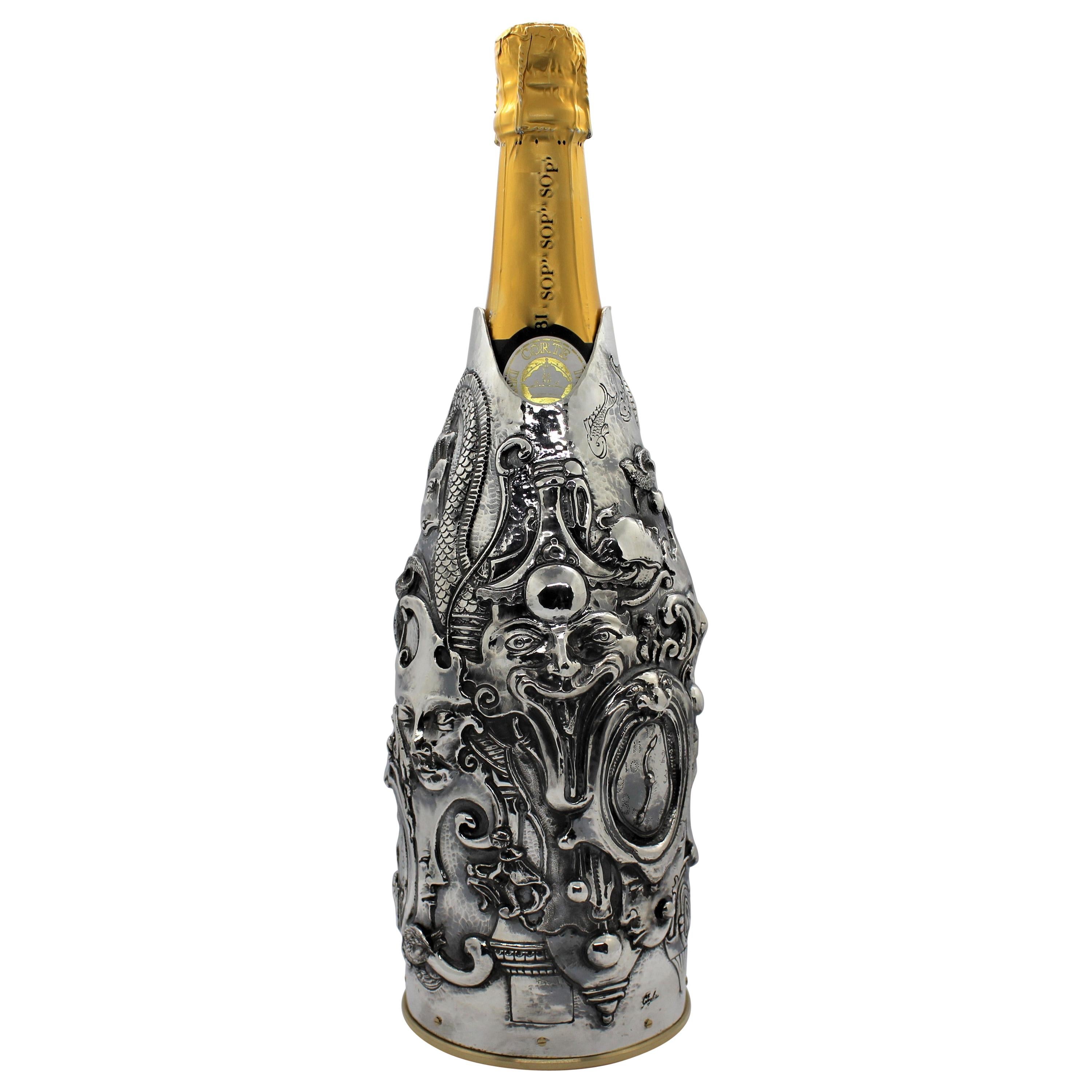 This champagne cover is a distinguished piece from our Works of Art collection, meticulously crafted to honor the renowned Surrealist artist Daniel Merriam. The Florentine artist has intricately chiseled a series of surrealistic images onto pure