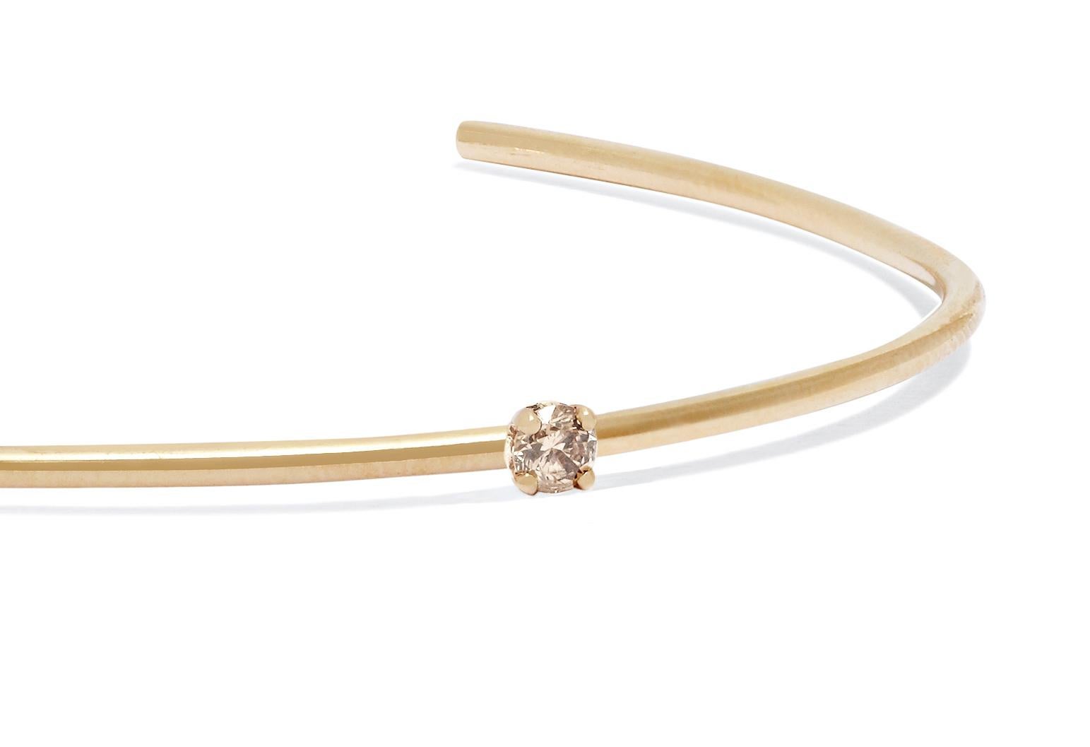 Clean-lined and elegant, this solid 18-carat yellow gold cuff features a champagne diamond set to sparkle at the wrist bone.  Diamond measures approximately 3 mm; 0.06 total carat weight. 

Handmade in London. Hallmarked 750 Allison Bryan London. 