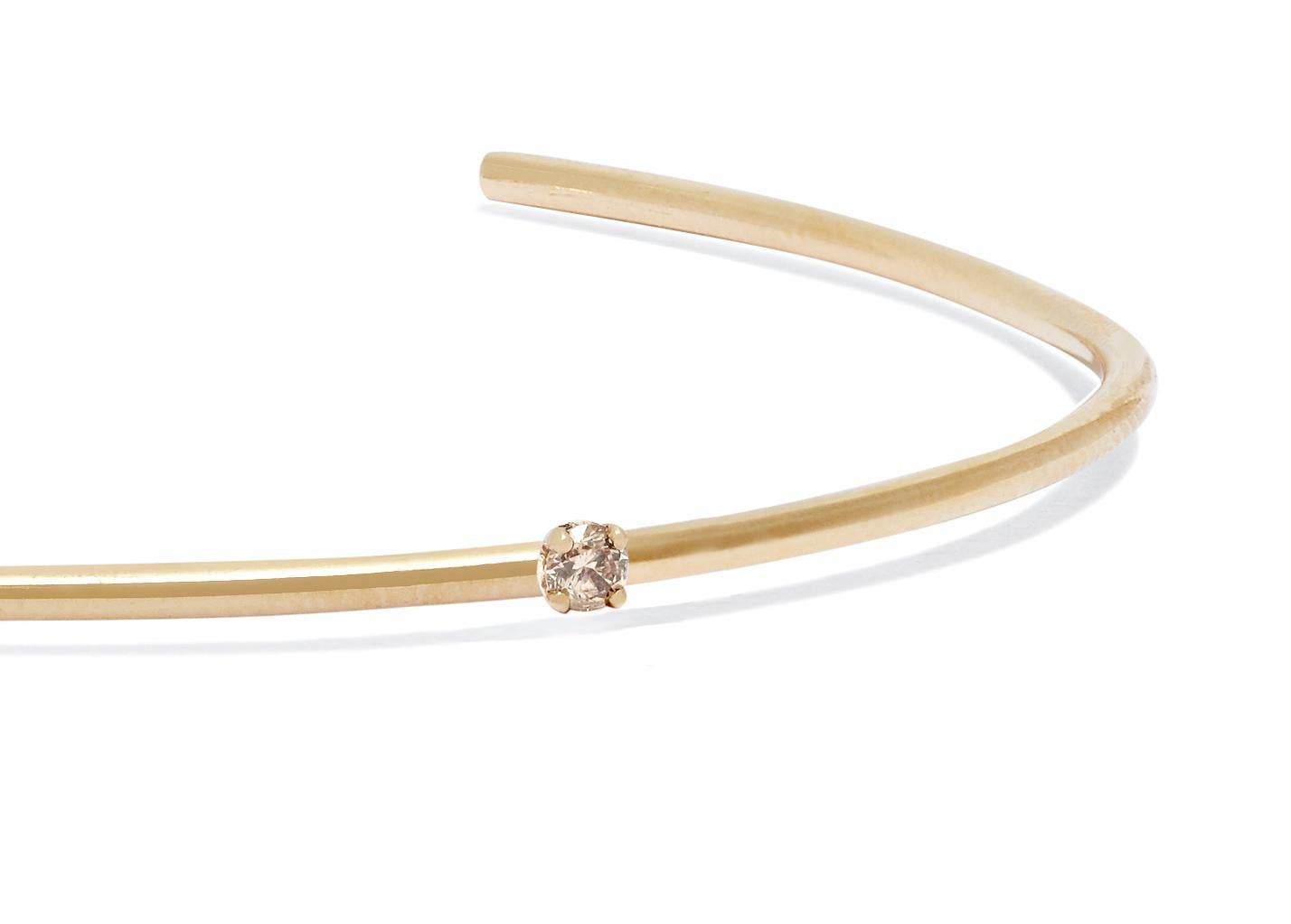 Clean-lined and elegant, this solid 18-carat yellow gold cuff features a champagne diamond set to sparkle at the wrist bone.  Diamond measures approximately 2 mm; 0.025 total carat weight. 

Handmade in London. Hallmarked 750 Allison Bryan London. 