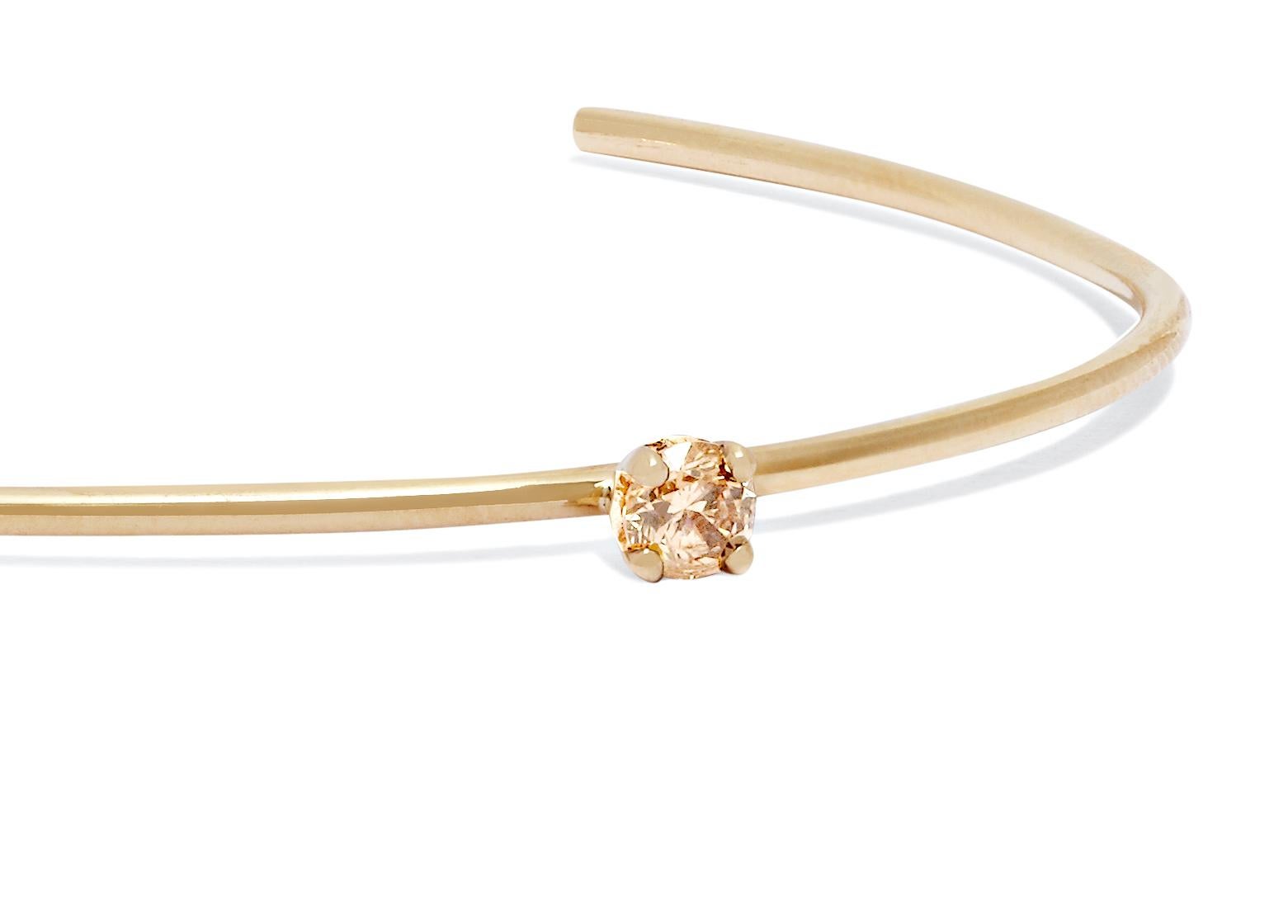 Clean-lined and simple, this solid 9-carat yellow gold cuff features a champagne diamond set to sparkle at the wrist bone.  Diamond measures approximately 3.9mm or one quarter of a carat.

Handmade in London. Hallmarked 375 Allison Bryan London. 
