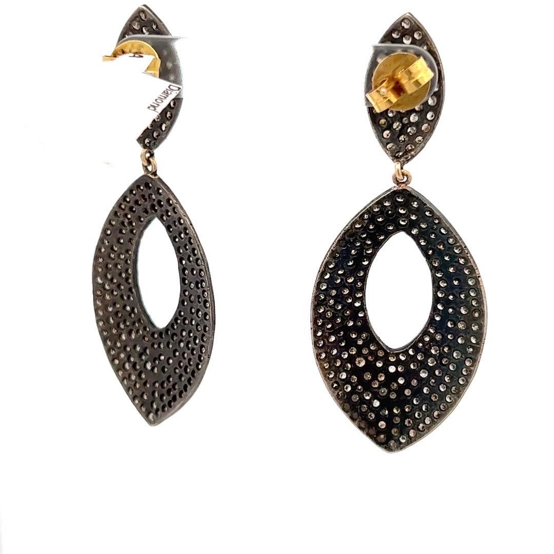 Champagne Diamond Dangle Earrings in Yellow Gold with Black Rhodium Finish. Each diamond is securely prong set in yellow gold. What sets these earrings apart is their unique black rhodium finish, which envelops the gold setting and creates a