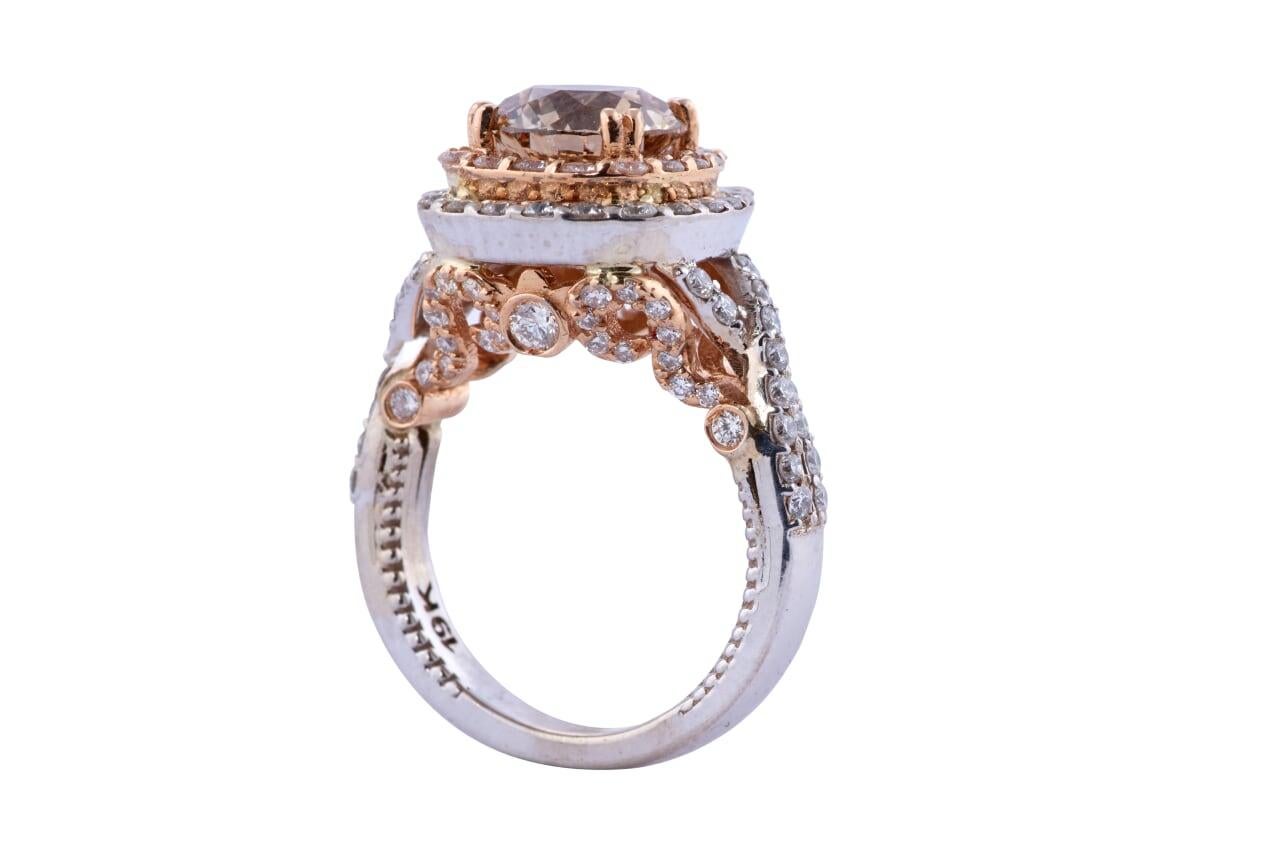 Beautiful champagne diamond engagement ring. The Champagne center diamond is weighing approx 2.45ct of VS1 clarity in light cognac color and accompanied by diamonds weighing approx 1.35ct/tw of VS clairty and G-H color.
The ring is set in 19kt white