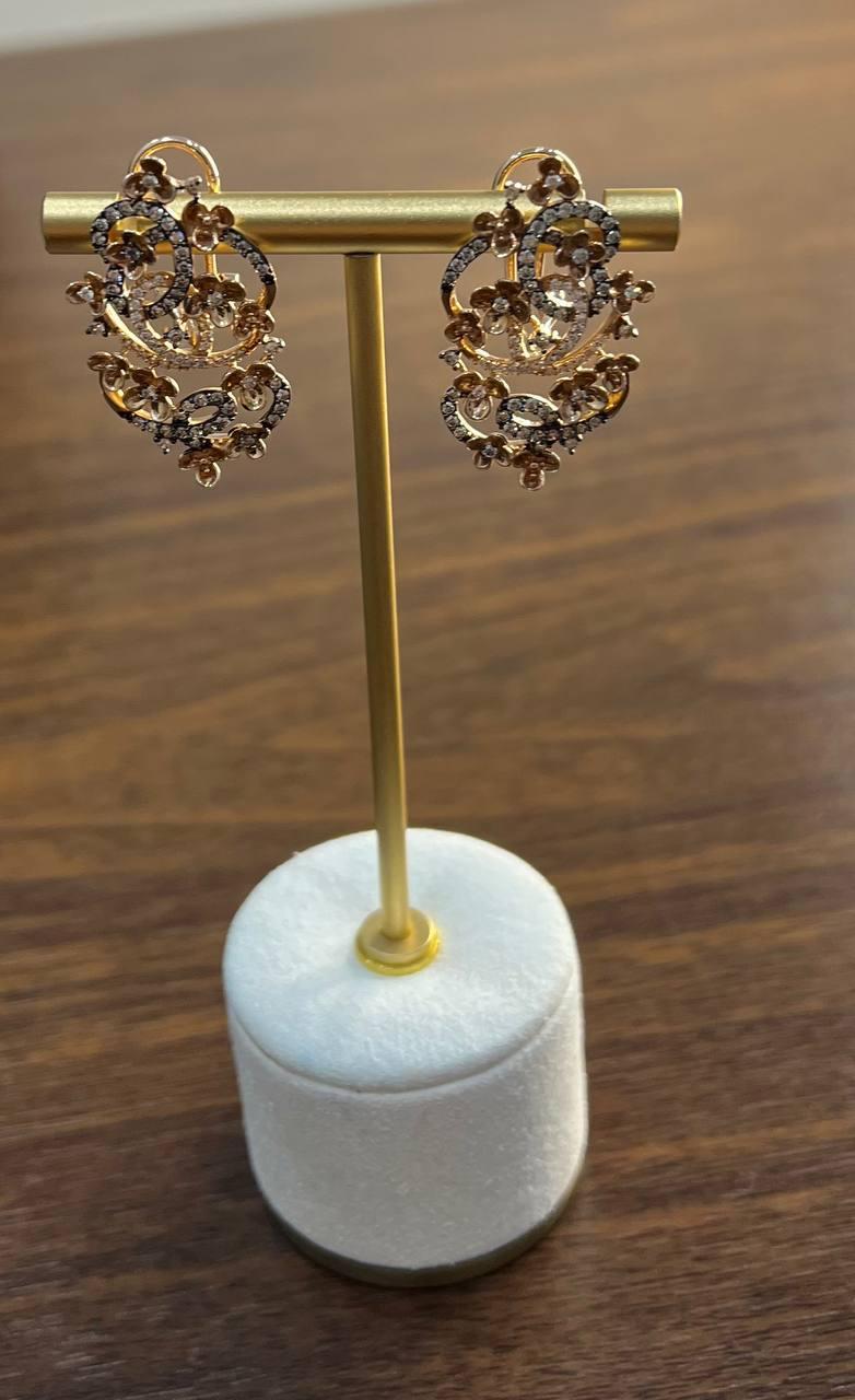 Elegant Diamond Cluster Earrings with Intricate Floral Design. These exquisite earrings feature a delicate arrangement of floral motifs, adorned with shimmering diamonds. The intricate craftsmanship showcases a blend of elegance and sophistication.