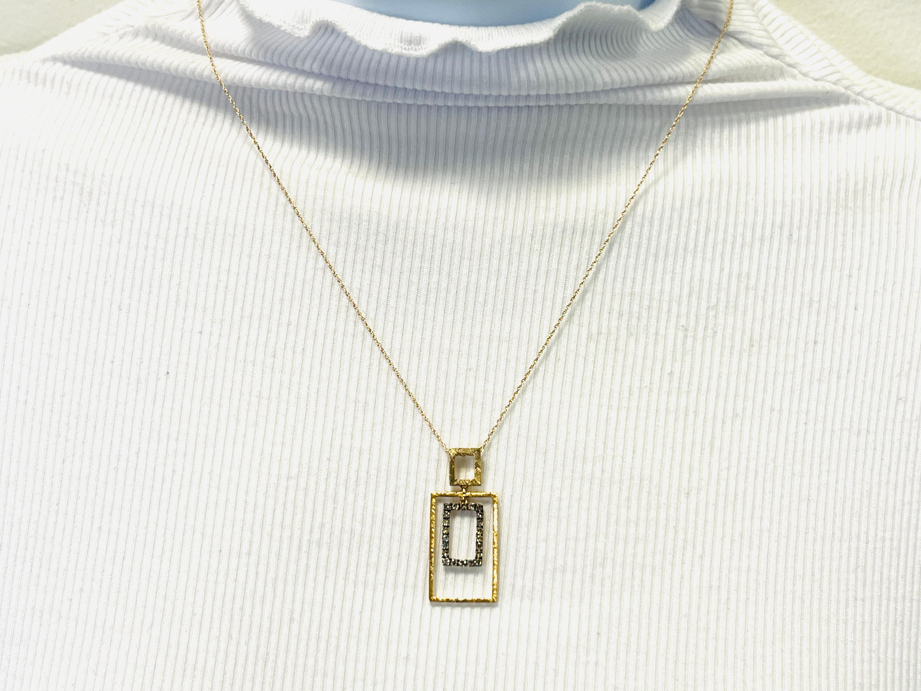 Beautiful pendant with 0.37 ct. good quality champagne diamond rounds.  Handmade in 13k yellow and black rhodium.  Length of chain is 18