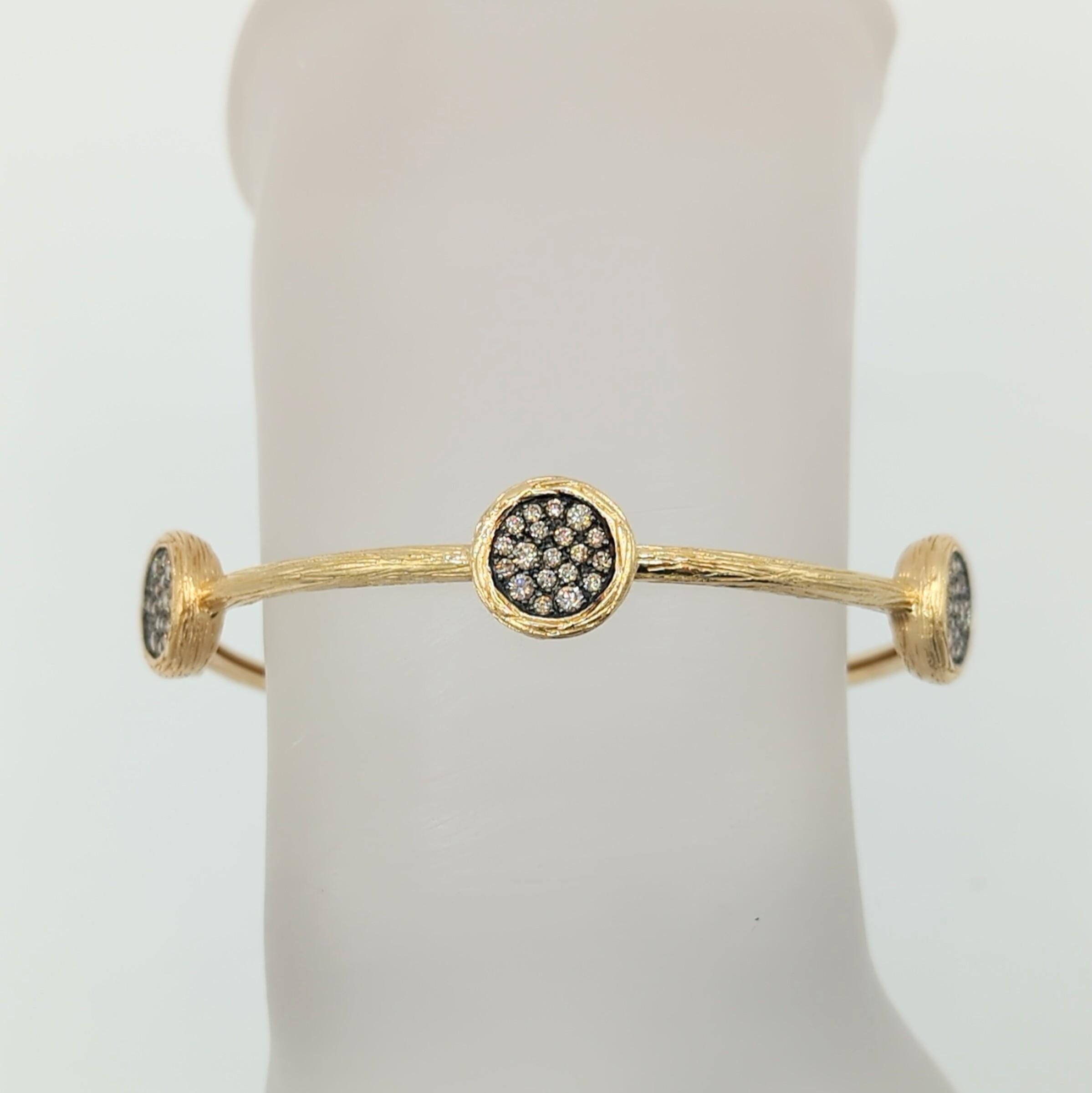 Beautiful 0.90 ct. champagne diamond rounds handmade in 14k textured yellow gold.  This bangle is fun and easy to wear with any outfit.