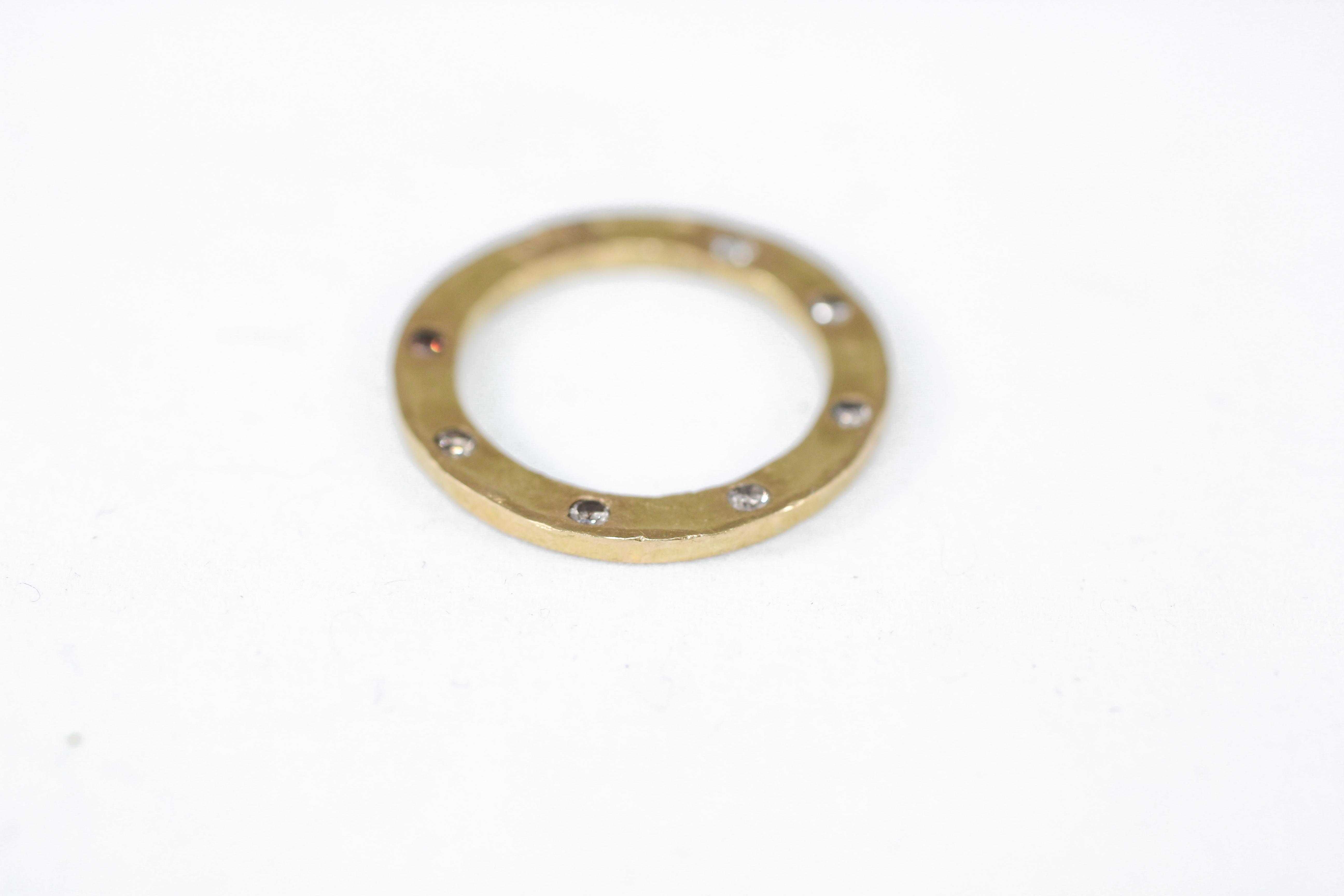 A bridal or wedding ring featuring 7 champagne diamonds in recycled 22k gold. A contemporary unisex wedding or bridal ring designed and handcrafted by AB Jewelry NYC. The whimsy of the Dial design is a peekaboo effect as the diamonds are set on the