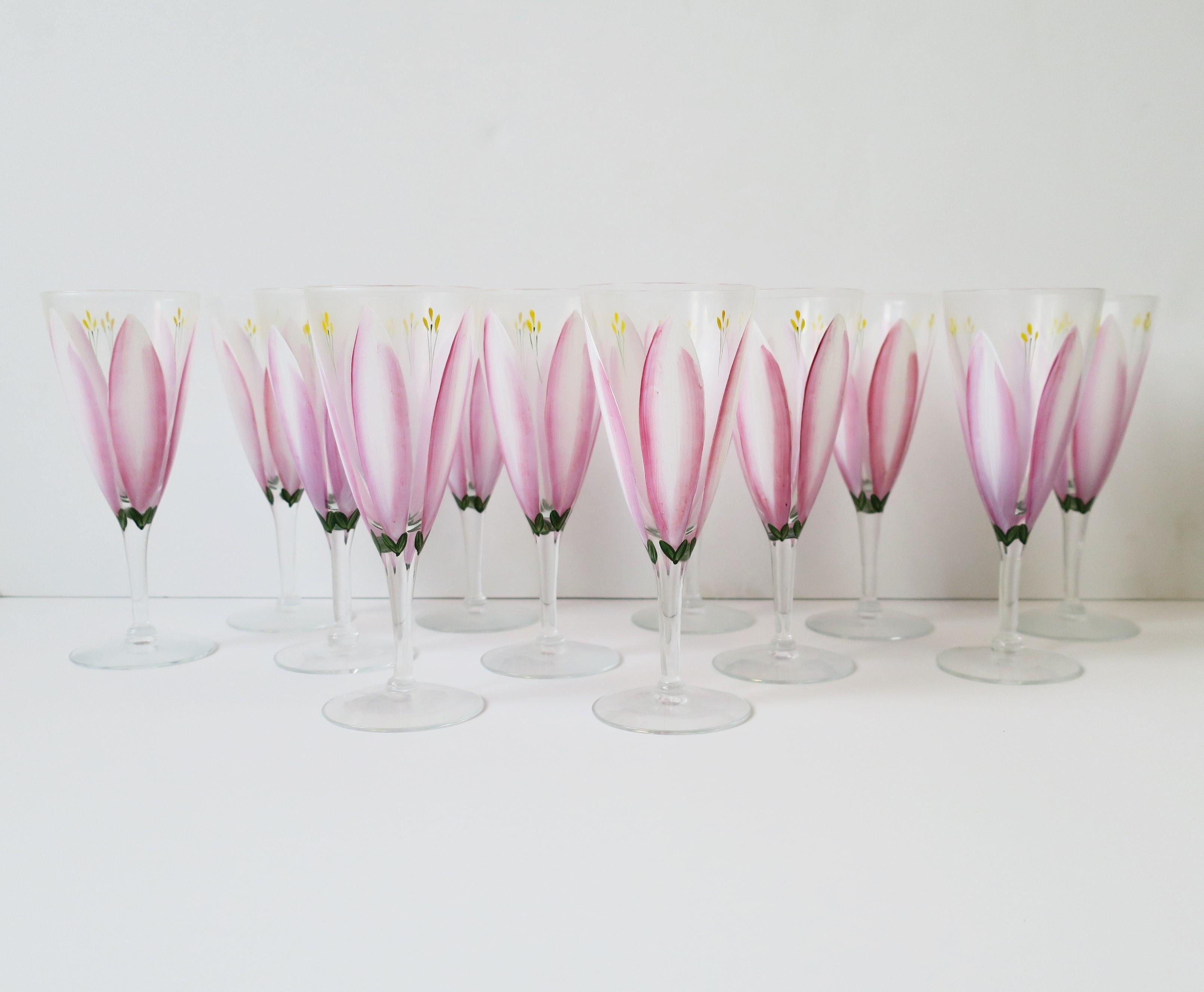 A gorgeous set of twelve (12) pink and white tulip Champagne flutes glasses, circa late-20th century, Europe. Glasses are beautiful, hand-painted in pink, white, and a touch of yellow and green hues. Together, glasses look like a beautiful garden of