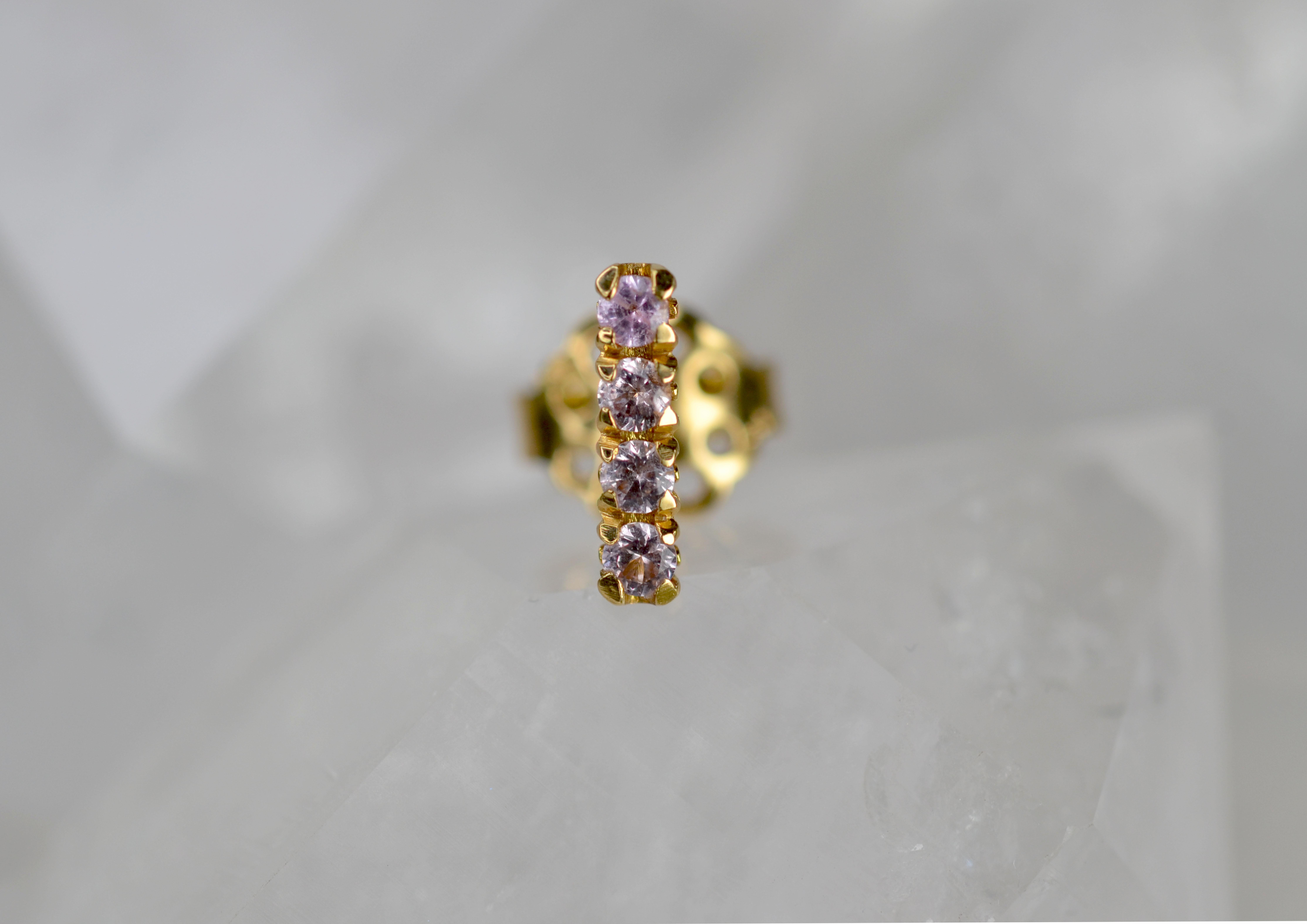 This single earring stud is part of our Blossom Collection of mix and match pieces. The glistening champagne garnets are set on an 18k gold blossom flower collet to be worn alongside your favourite pair of earrings, our blossom hoops, or combine