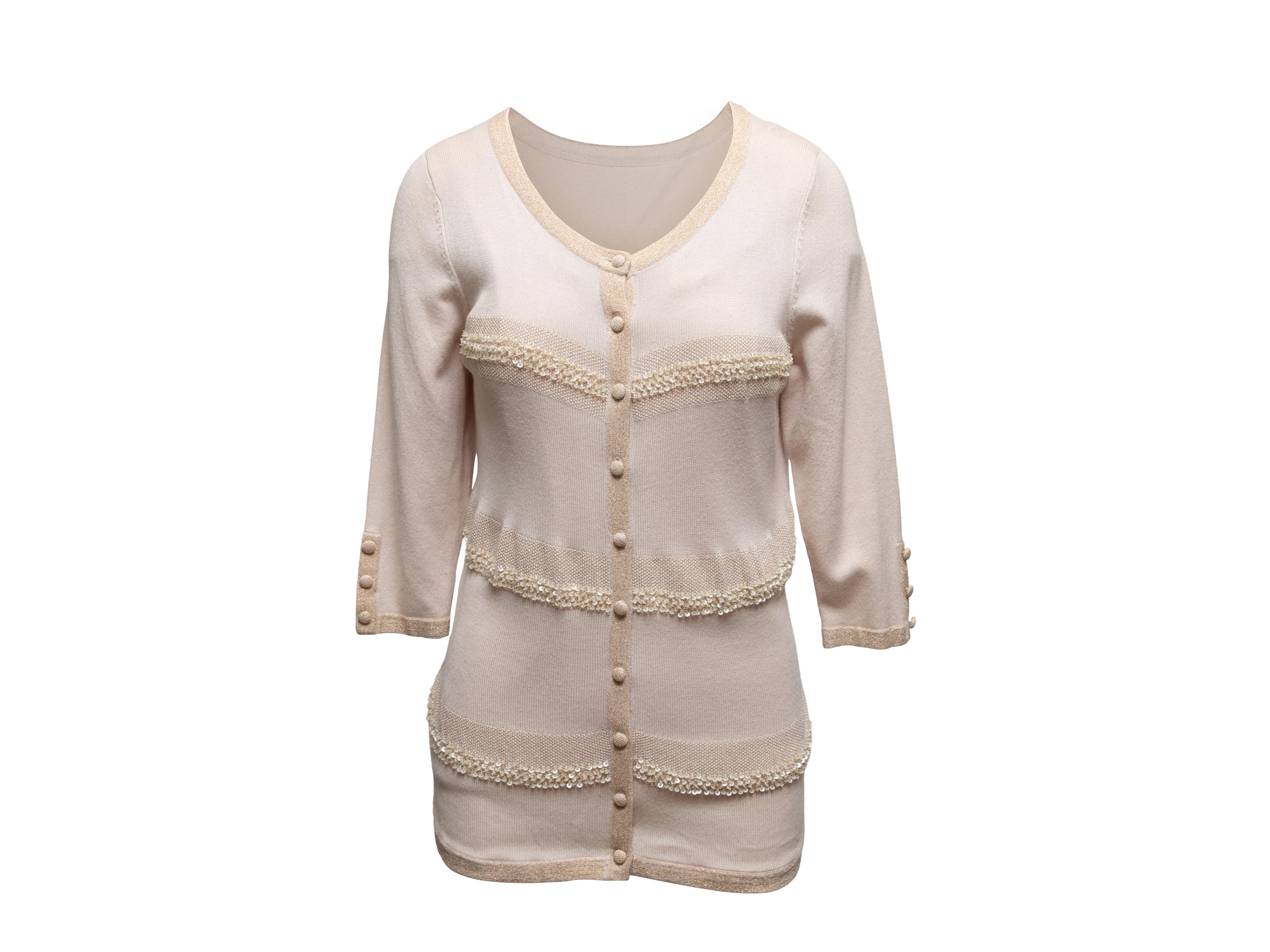 Champagne and gold knit cardigan and sleeveless top set by Valentino. Top features scoop neckline. Cardigan features scoop neckline, sequin embellishments, three-quarter length sleeves, and front button closures. Top- 30
