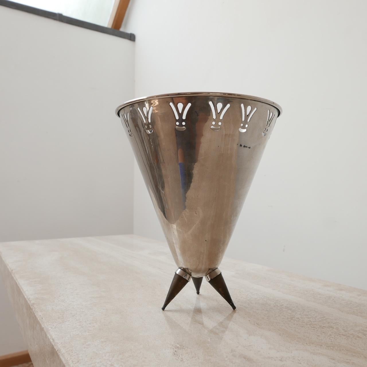 A well used champagne bucket attributed to design legend Philippe Starck. 

Patina and aging to the tripod brass legs,

France, c1990s. 

Good condition and perfectly usable. 

Dimensions: 24 diameter x 28 height in cm. 

Delivery: