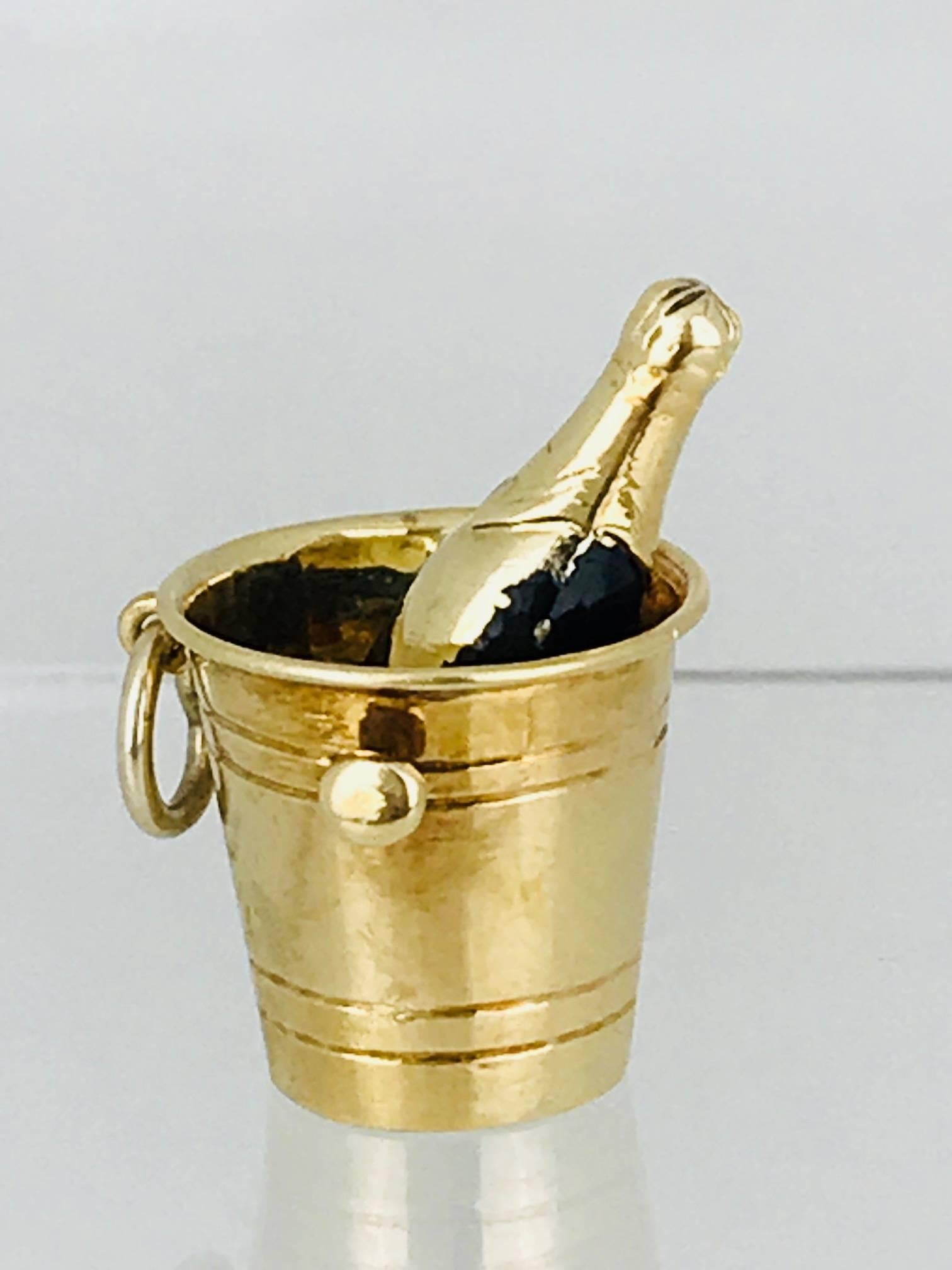 Champagne on Ice Bucket. Champagne bottle shows black enamel and gold made of 14 Karat Yellow Gold.
Circa 1950's
Vintage, unique and rare charm can be used for charm bracelet or necklace

GIA Gemologist, inspected & evaluated