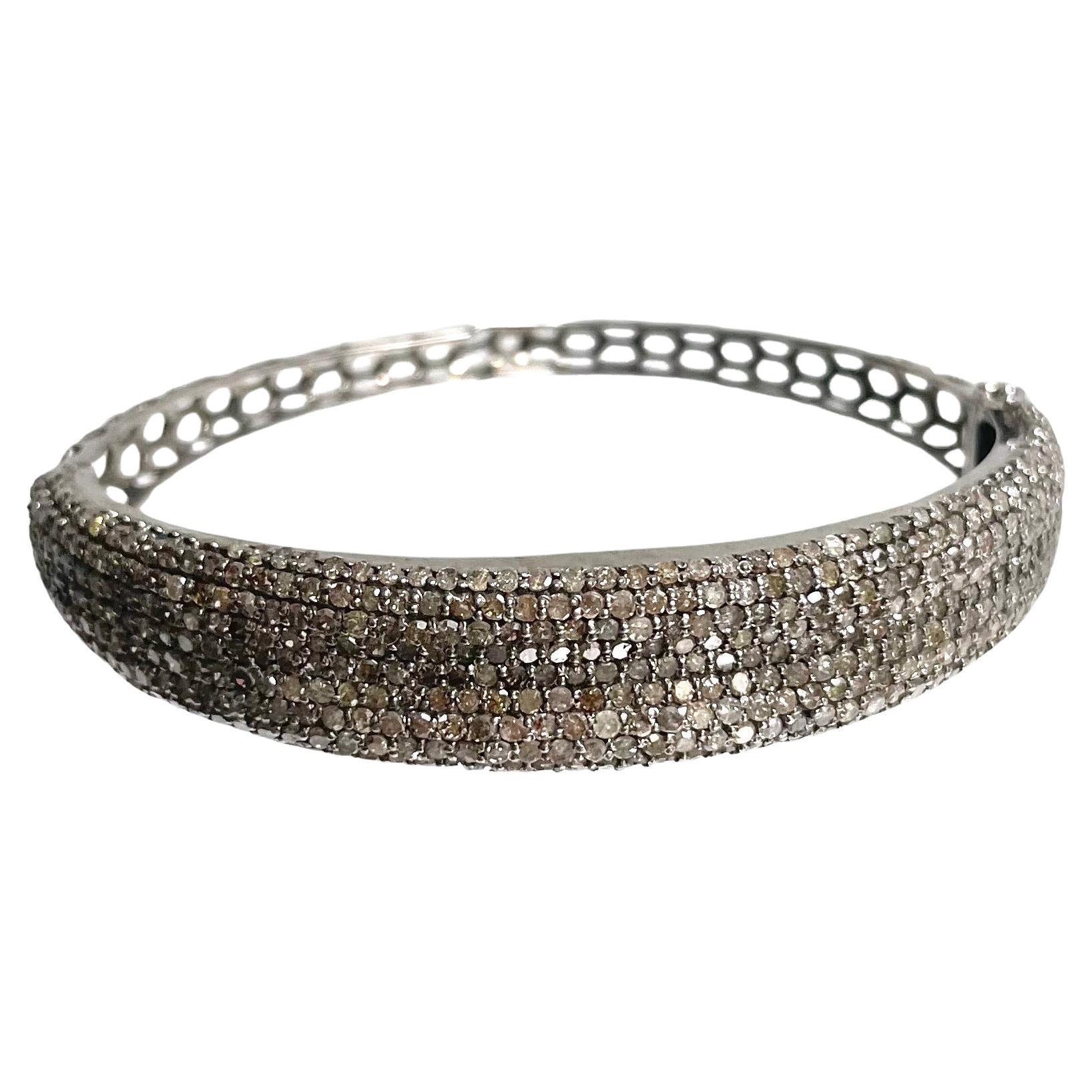Description
Twinkling champagne diamonds sparkle with soft sophistication creating an elegant yet subtle and chic easy to wear bracelet. This hinged bangle is thoughtfully designed in an oval shape allowing the beauty of the 7.25 carats of diamond