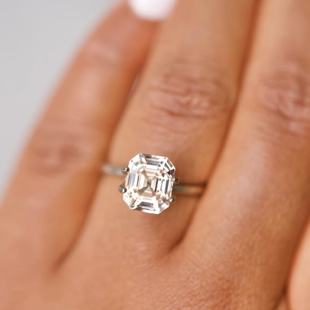 An impressive large 4 carat champagne peach sapphire with a tempting pinkish yellow complexion. Exquisitely emerald cut with lively linear facets this champagne peach sapphire of Sri Lankan origin and with no indication of heat treatment would make