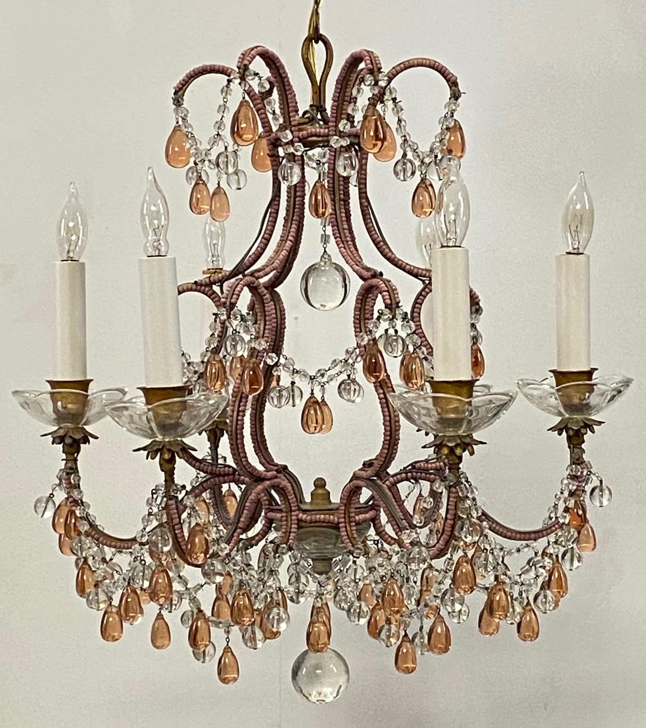A splendid pink champagne chandelier. Having double pink beads on the arms and cage, and with pink and clear glass drops and pendants.
Recently cleaned and re-wired.
Italy, circa 1950.
Measurement of light only is 17 inches high. We can shorten