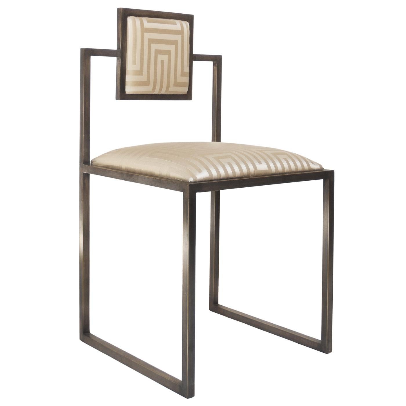 This chair is simple and square in design and features an elegant solid brass handcrafted structure. The comfortable seat and back are upholstered using only the finest fabrics. This one in particular features fabric from Dedar Milano called Dedalus