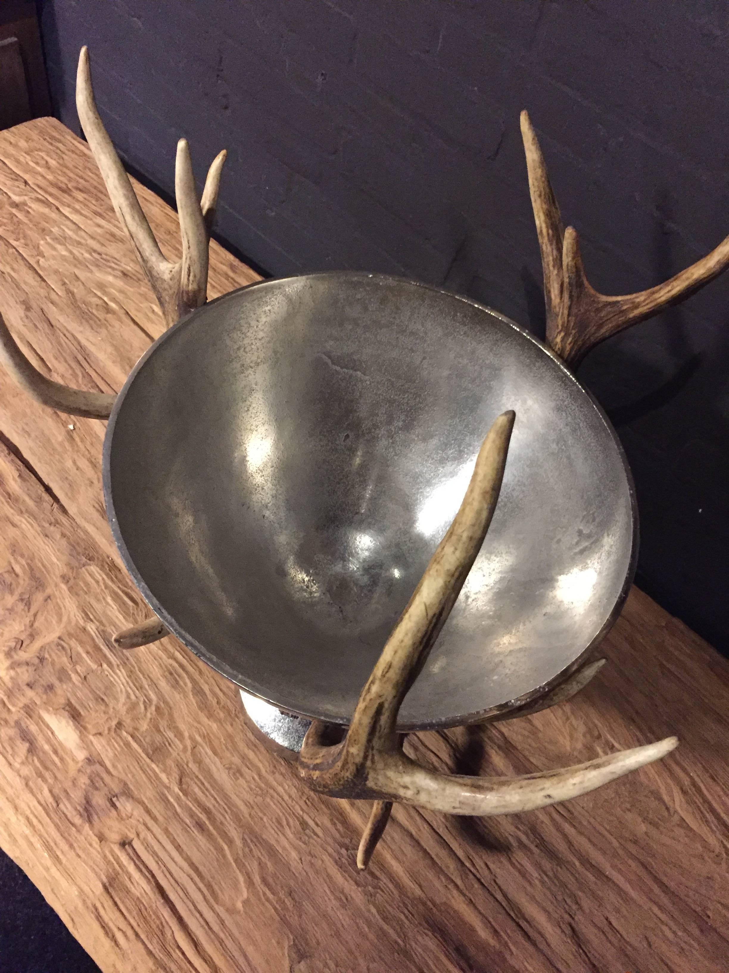 Champagne or wine cooler decorated with heavy red deer antlers.