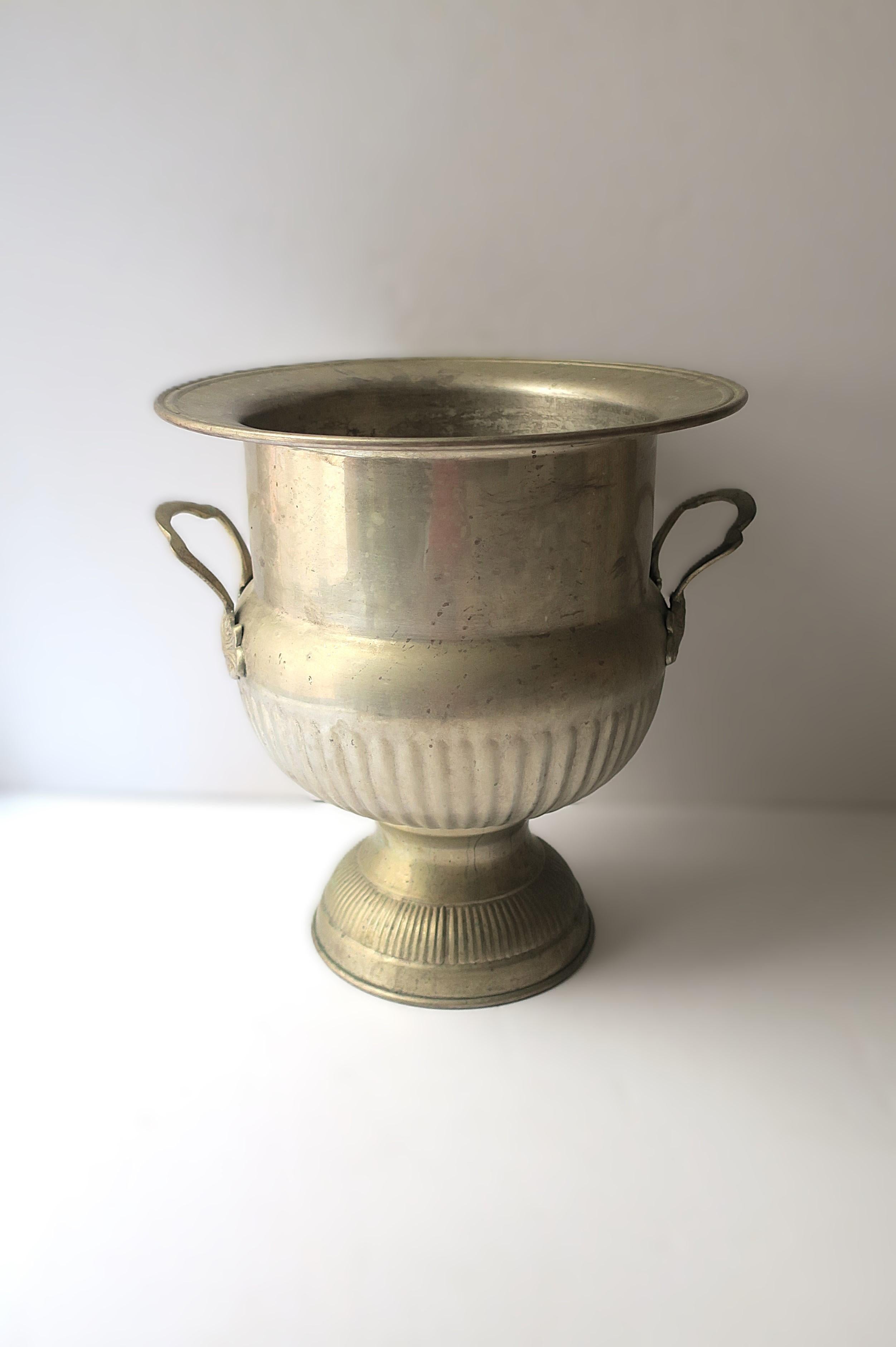 A large size vintage Champagne cooler ice bucket, circa early to mid-20th century. Piece can fit comfortably four (4) bottles of Champagne. A hotel/restaurant size piece. Great for chilling Champagne, wine, vodka, water, etc., or to hold ice (ice