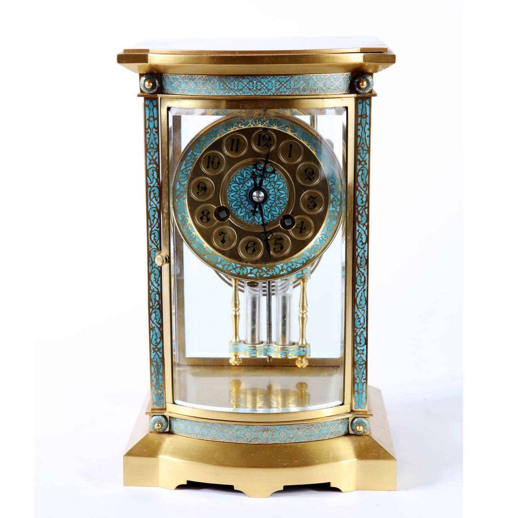 The clock and movement with blue enamel, the dial marked 1-12 with no minutes. The 8 day movement with a mercury filled pendulum.
French, circa 1880

Measures: Height 25cm
Width 16cm
Depth 13cm.