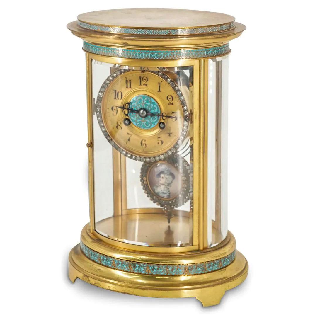 Our lovely champleve enameled bronze and glass mantel clock with movement by Japy Freres of Paris for Theodore B. Starr of New York City dates from the 1900s to 1910s and is distinguished for its clockface and pendulum decorated with faceted glass