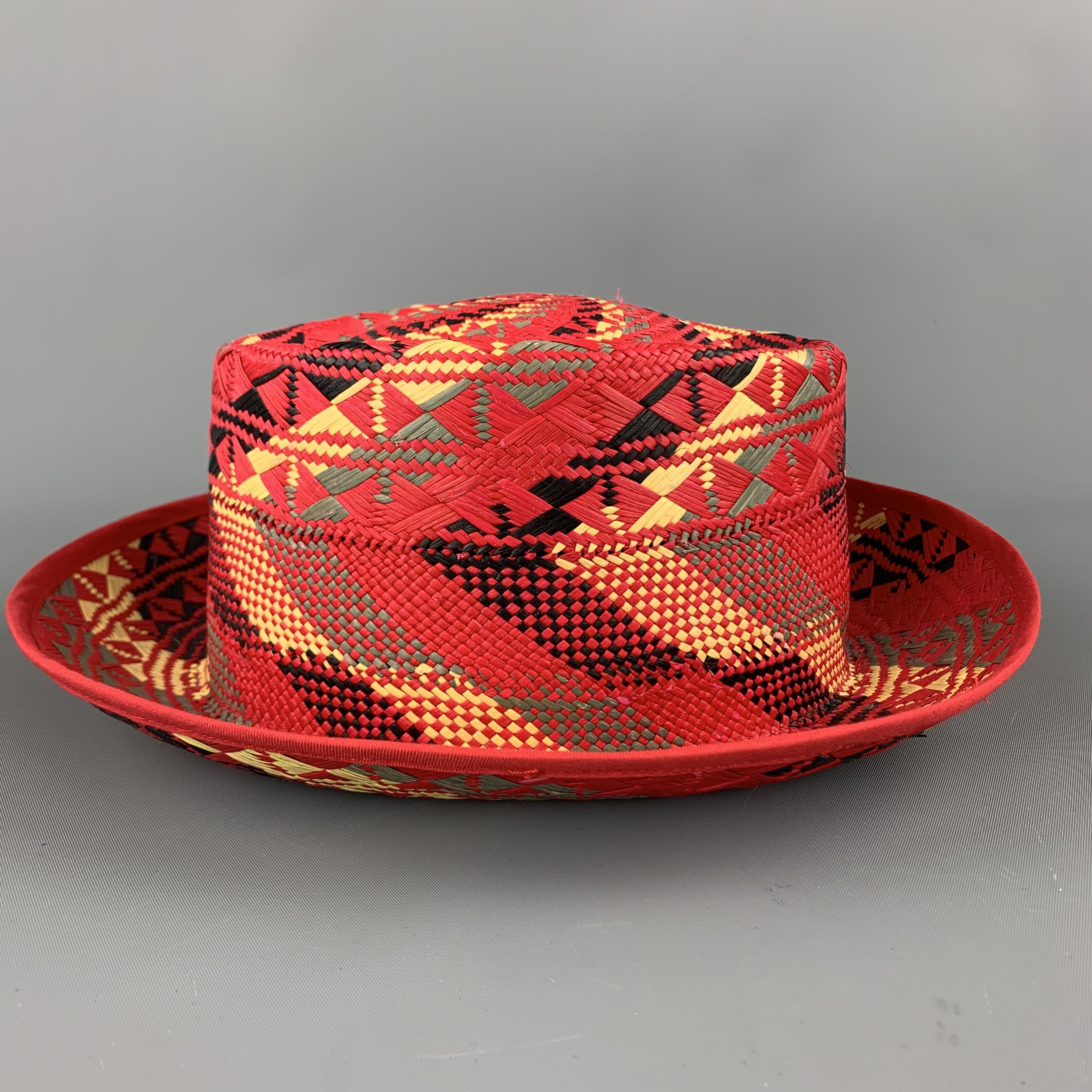 CHAMULA Panama hat comes in bold red woven straw with a black, yellow, and green pattern throughout. Hand woven in Ecuador. 

Excellent Pre-Owned Condition.
Marked: 58

Measurements:

Opening: 23 in.
Brim: 2.5 in.
Height: 4 in.