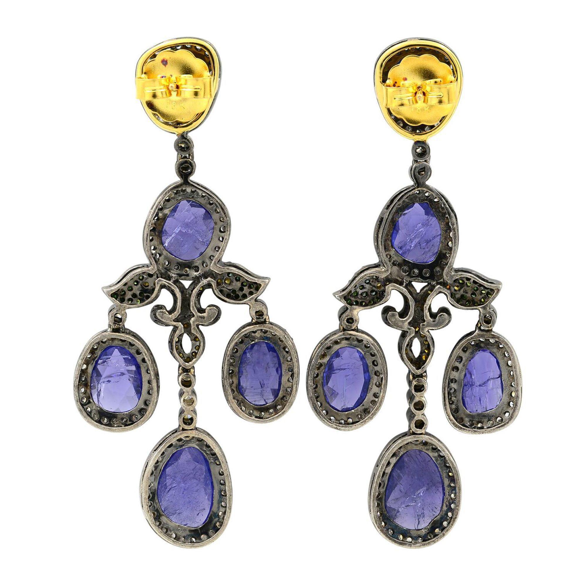 Measuring an impressive 2.5 inches long, these fabulous chandelier earrings swing and sparkle with a geometric array of bright diamonds and bright Tanzanites. Radiant rarities, lightly hand-fabricated in 18k white gold. Encrusted with 3.23 carats of