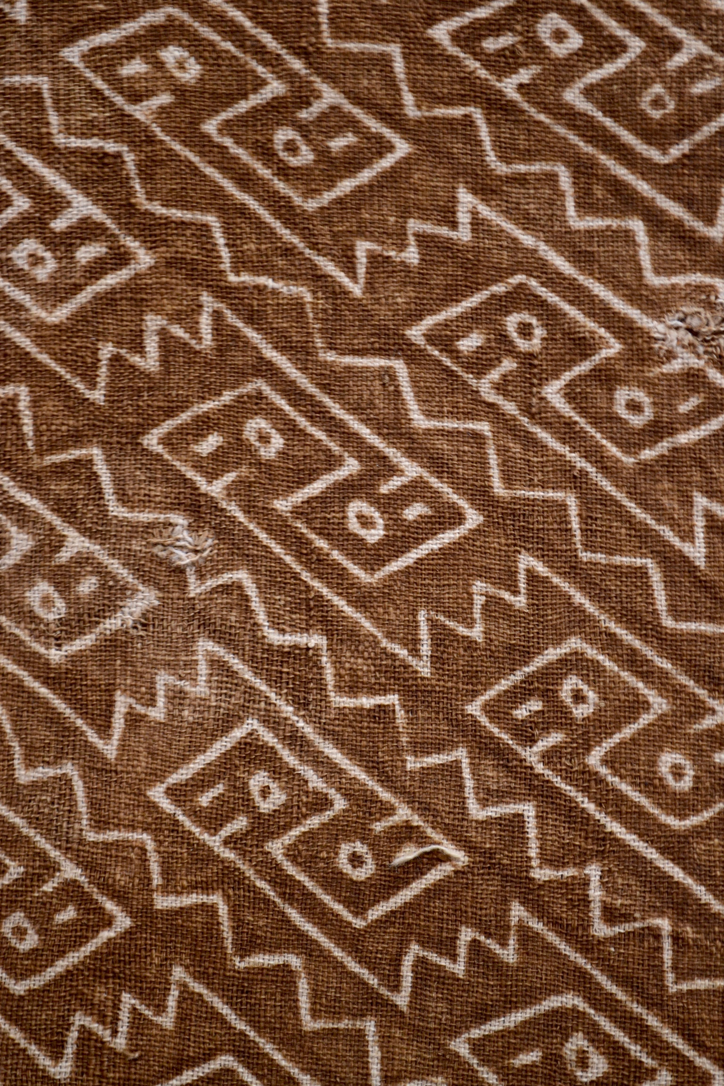Earth tones textile fragment. Puzzle like figures painted above a light pink stripe.

It is a wonder to behold antiquities such as a pre-Columbian textiles, an authentic piece of art that has been preserved for centuries and that survives