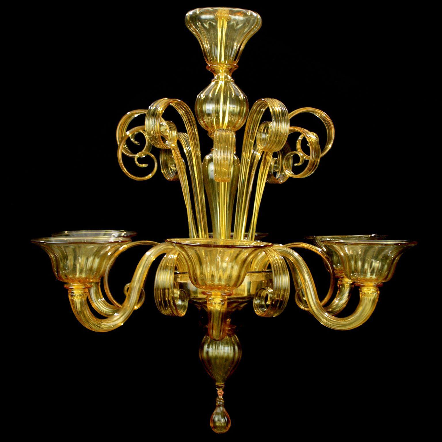 Capriccio by Multiforme is a 6 lights chandelier, in acacia artistic glass, with curly ornamental elements.
Inspired by the Classic Venetian tradition it is characterized by a central column where many blown glass “pastoral” elements are installed.