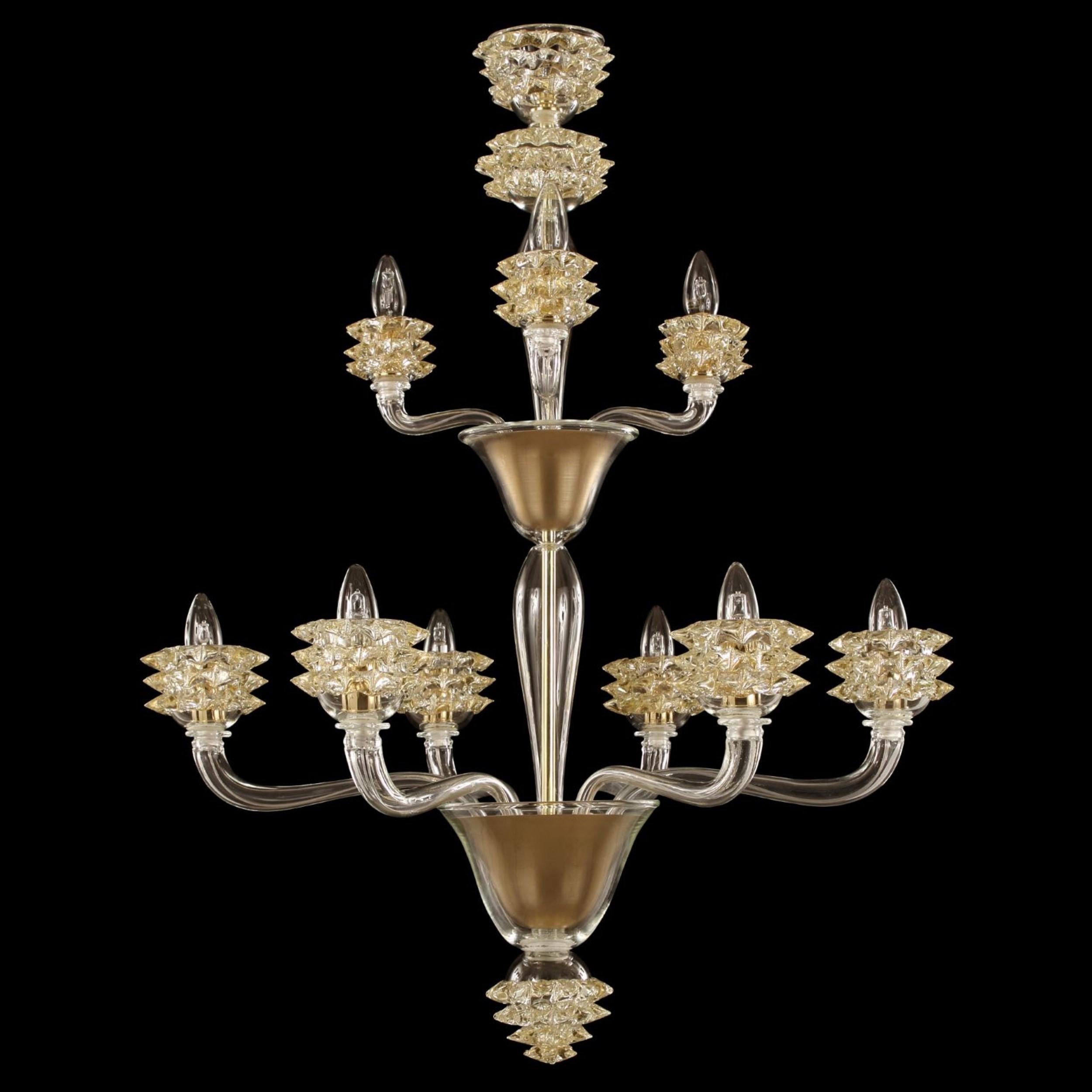Chandelier 6+3 arms, clear-gold Murano glass Diamante.
The diamante blown glass chandeliers are characterized by a slender central element.
The arms, central column and final cup are made of flawless smooth glass. The standout elements of this